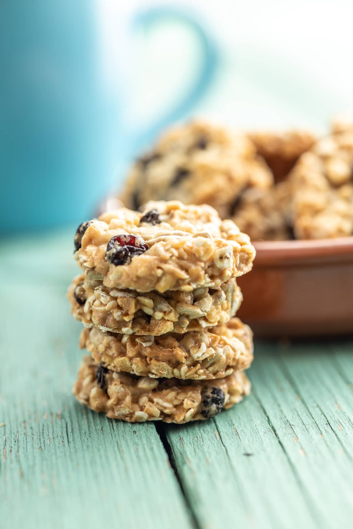 Wholegrain oat cookies. Cookies with oatmeal and raisins on the green wooden table.