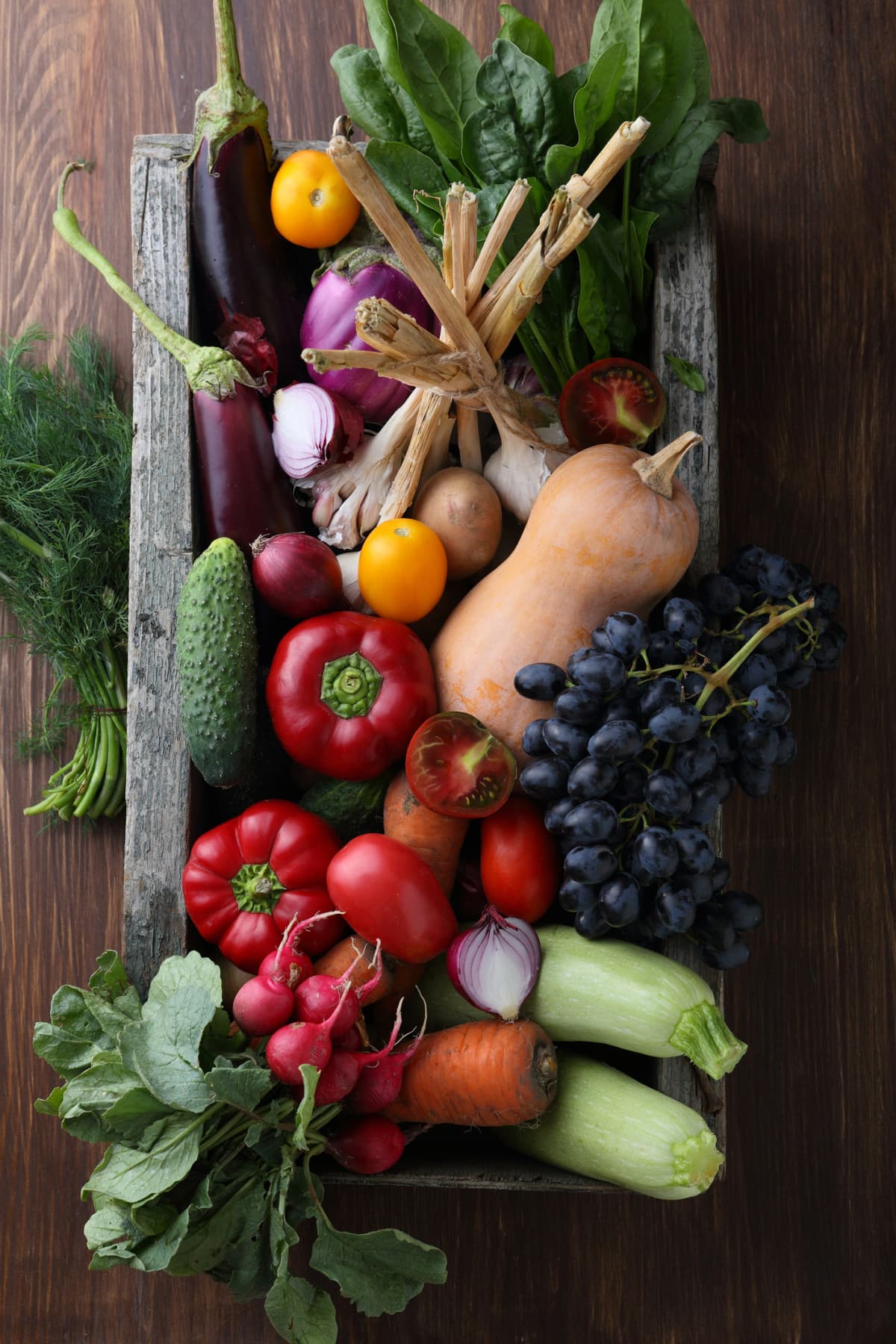 Fresh vegetables in wood crate, food above