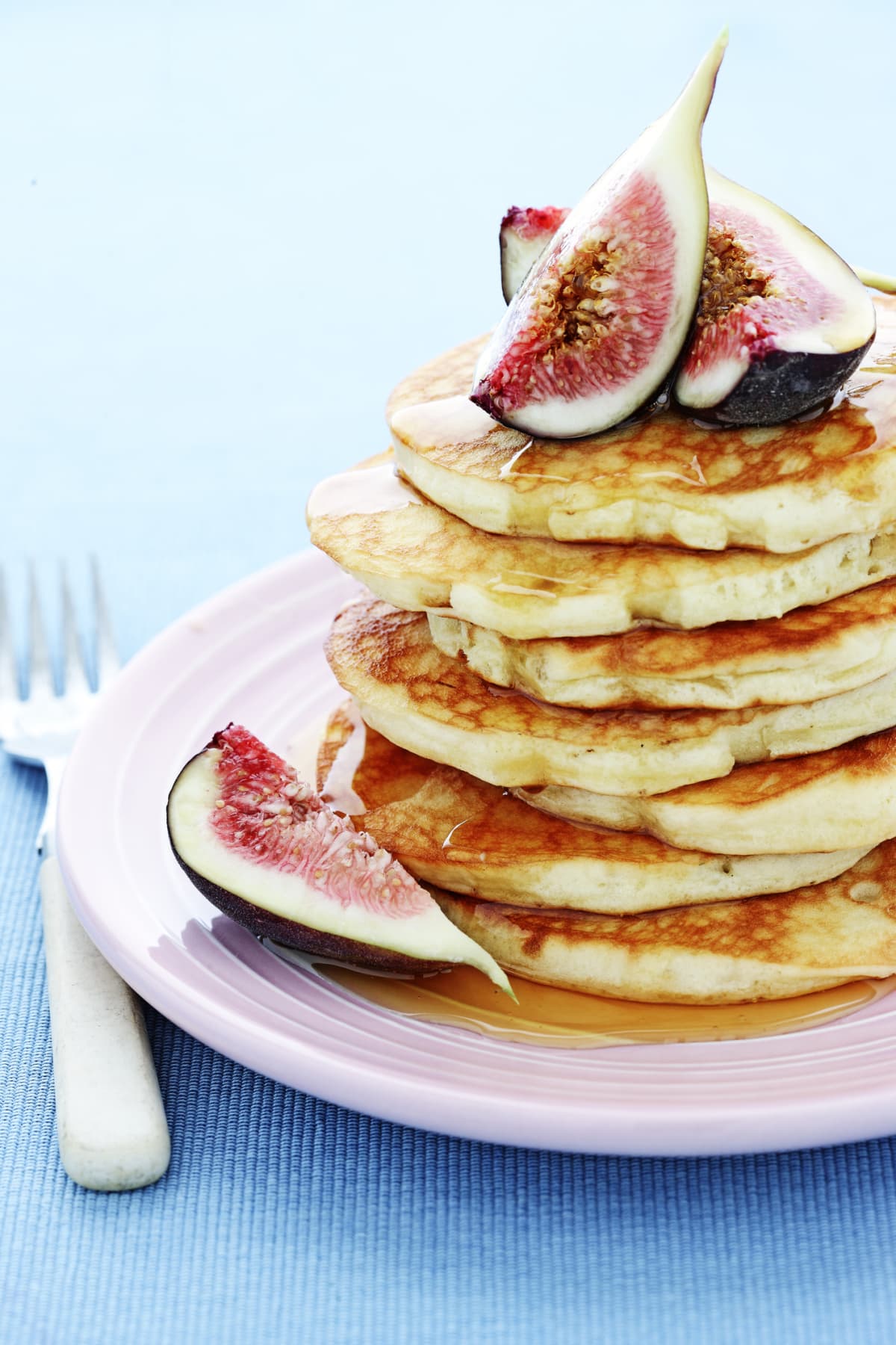 Stack of pancakes topped with figs
