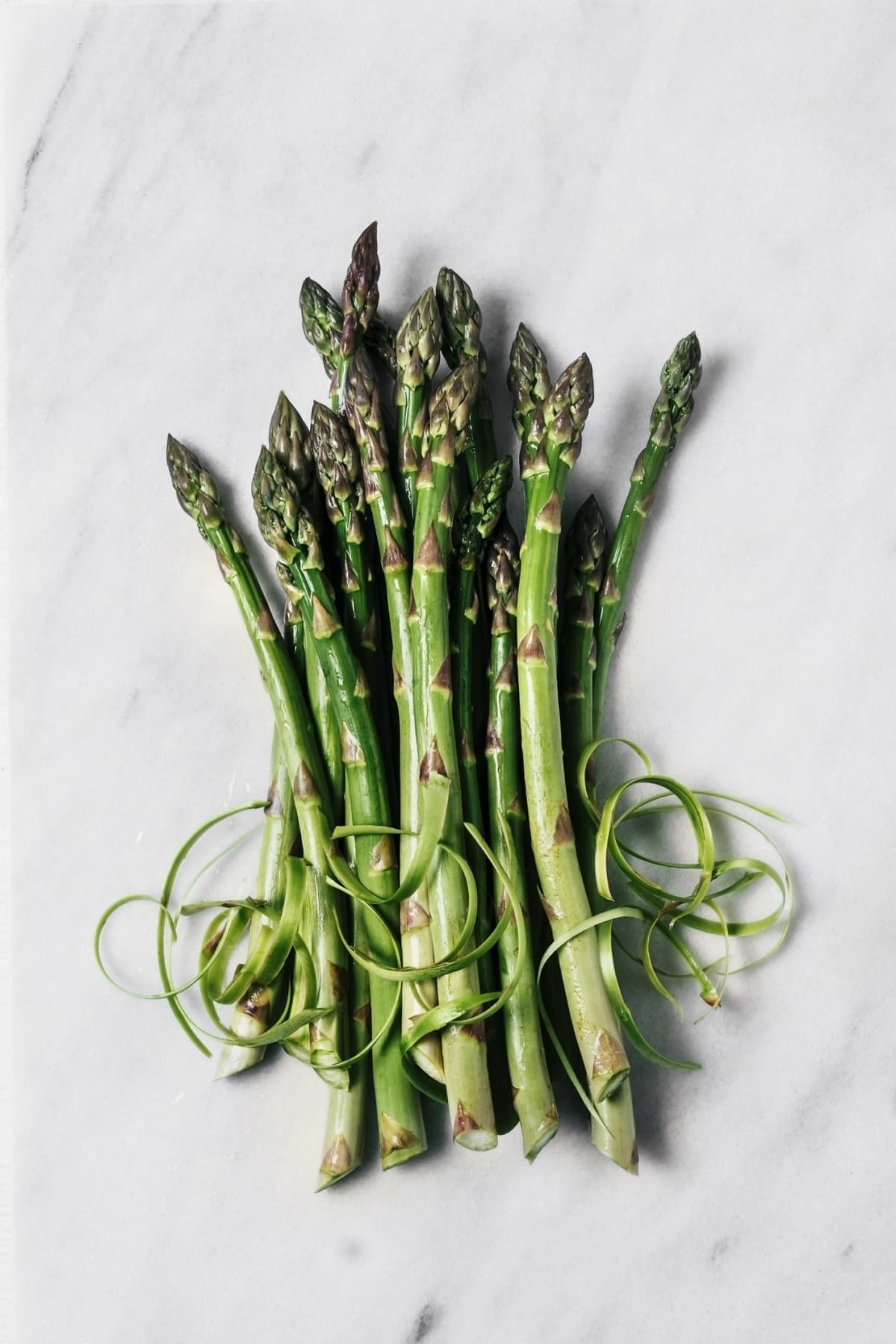 A bunch of fresh asparagus on white background