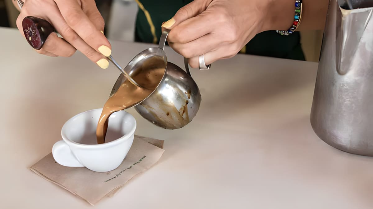 Barista pouring a cup of Cuban coffee