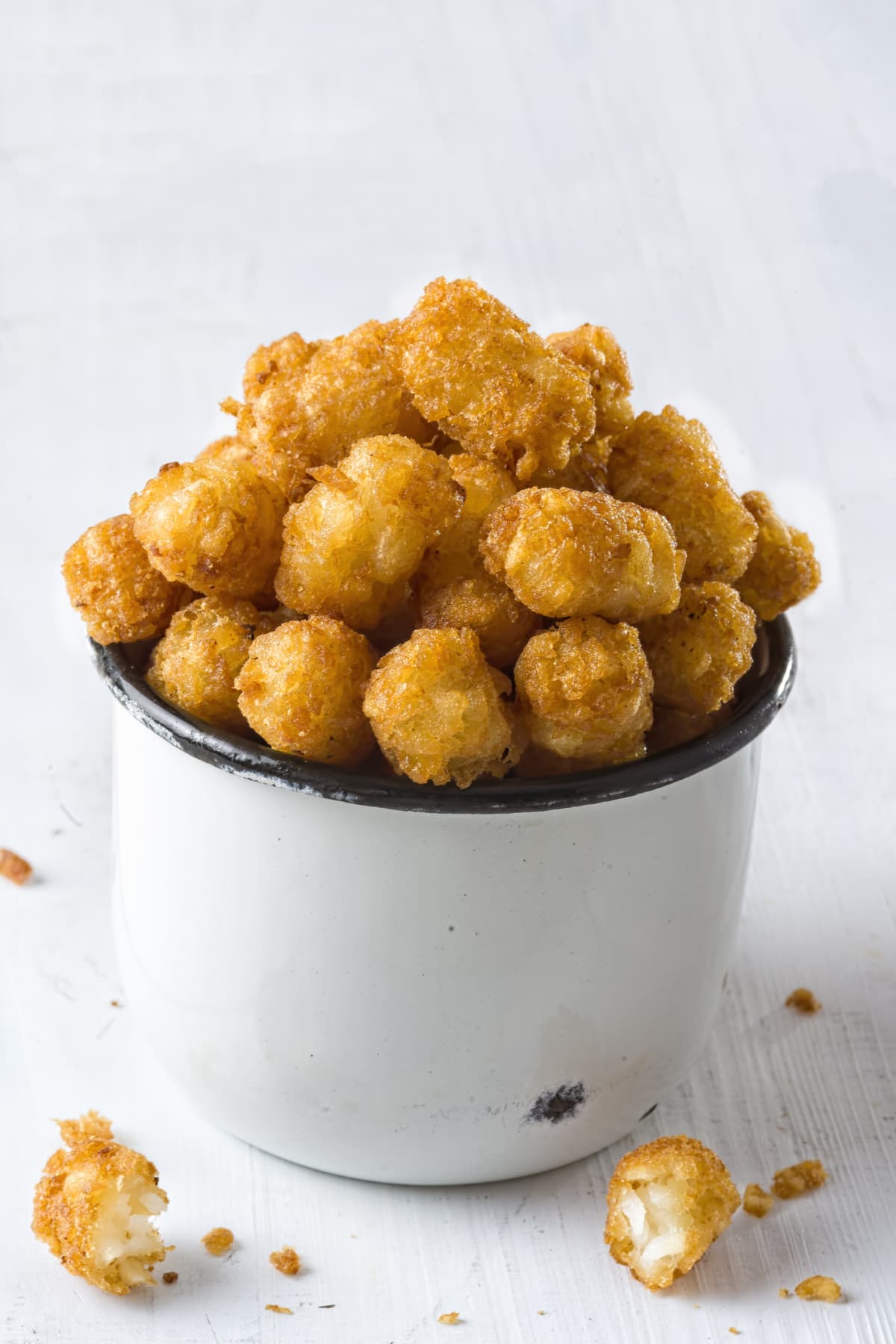 Container heaped full of tater tots