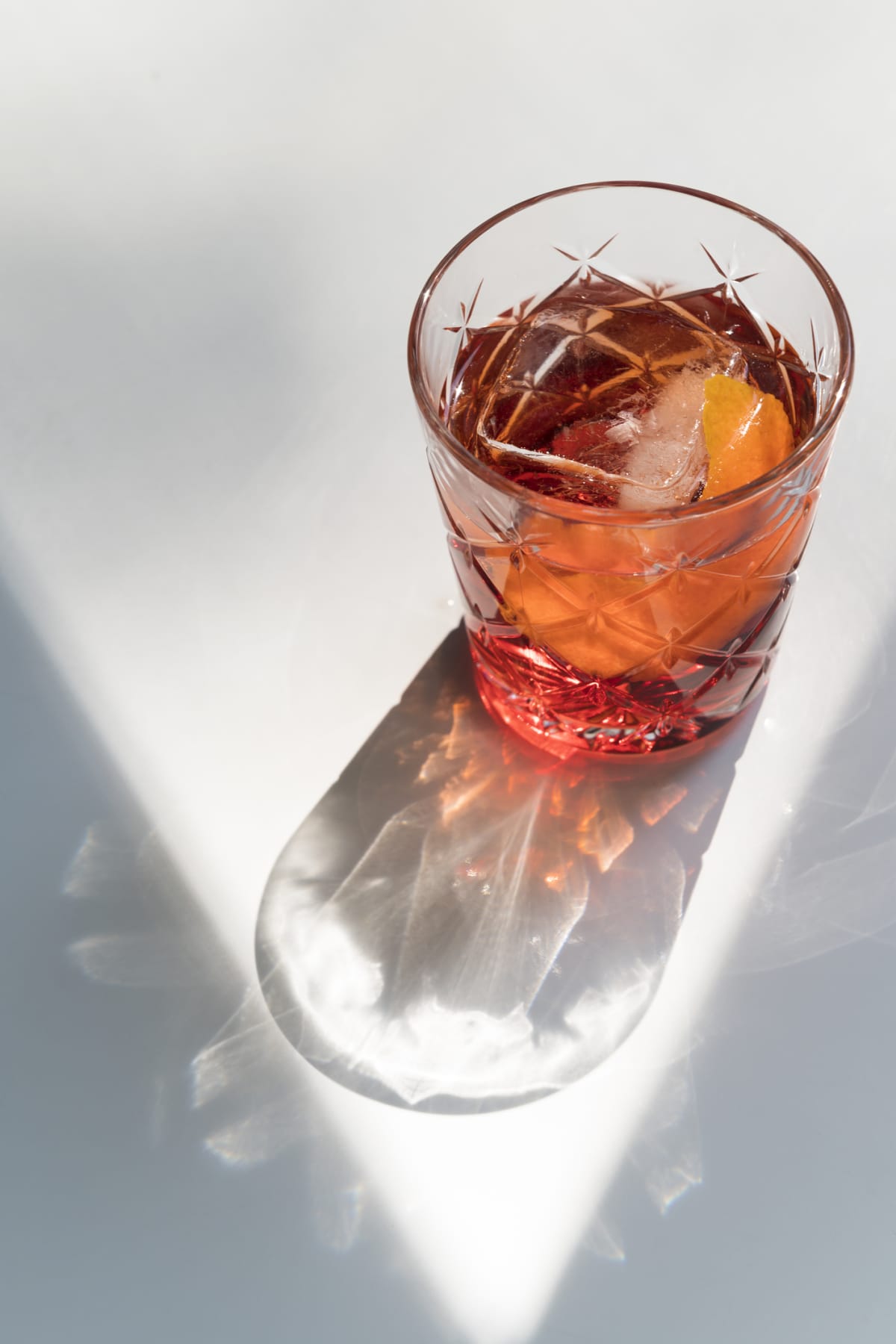 Negroni Cocktail in crystal glass with ice cubes