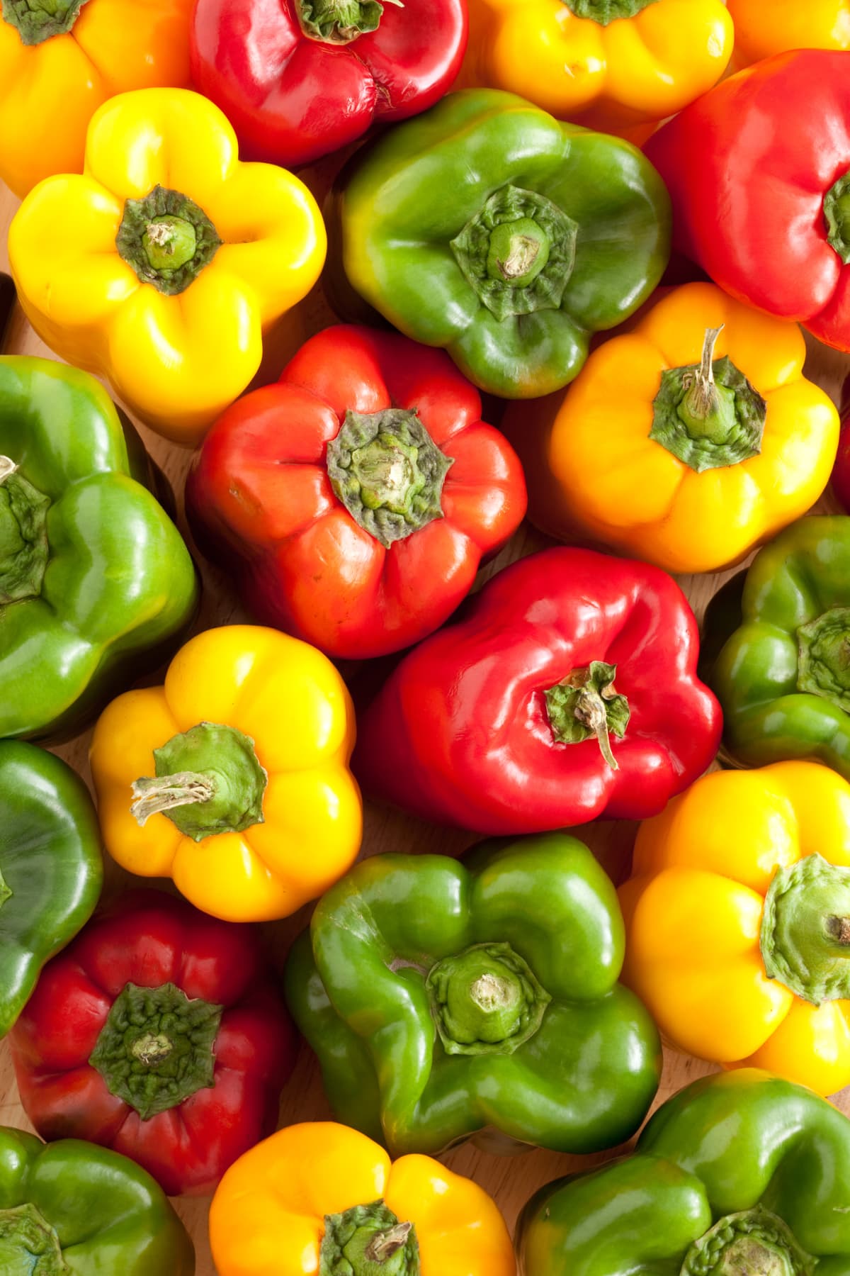 Overhead view of yellow, red, and green bell peppers