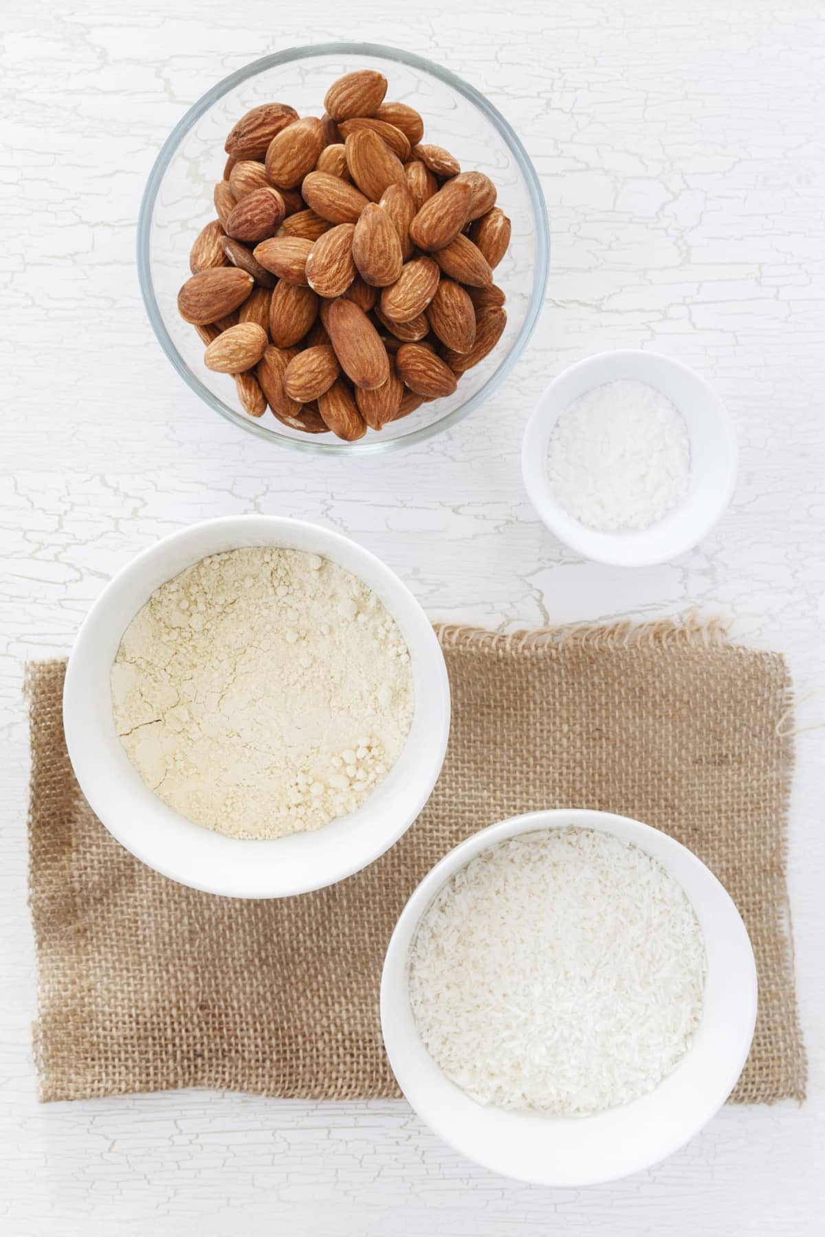 Bowl of almonds next to bowl of almond flour
