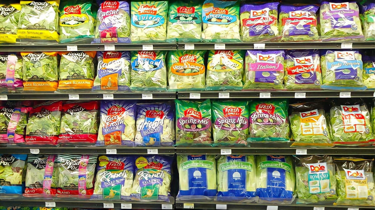 Salad mixes being sold on a shelf