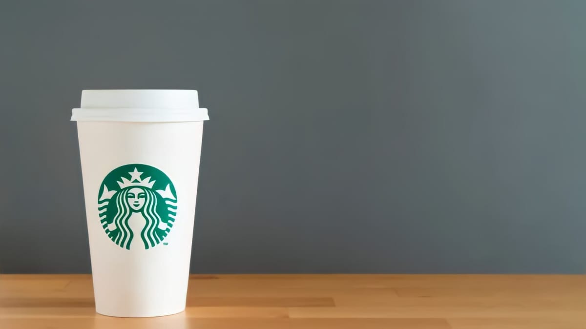 A Starbucks cup on a grey background