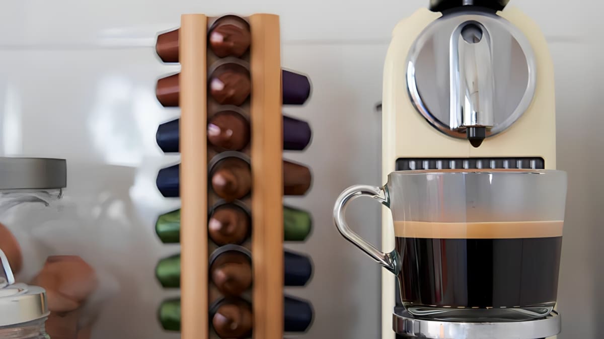 A Nespresso machine with a cup of coffee