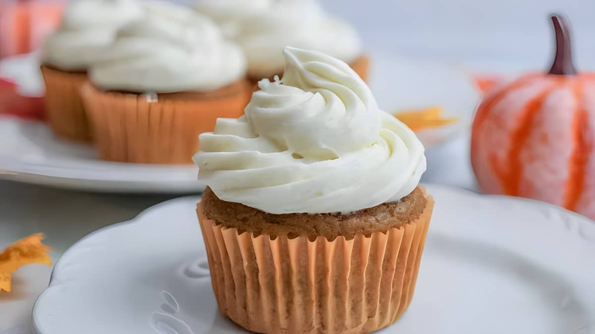 A pumpkin cupcake with frosting