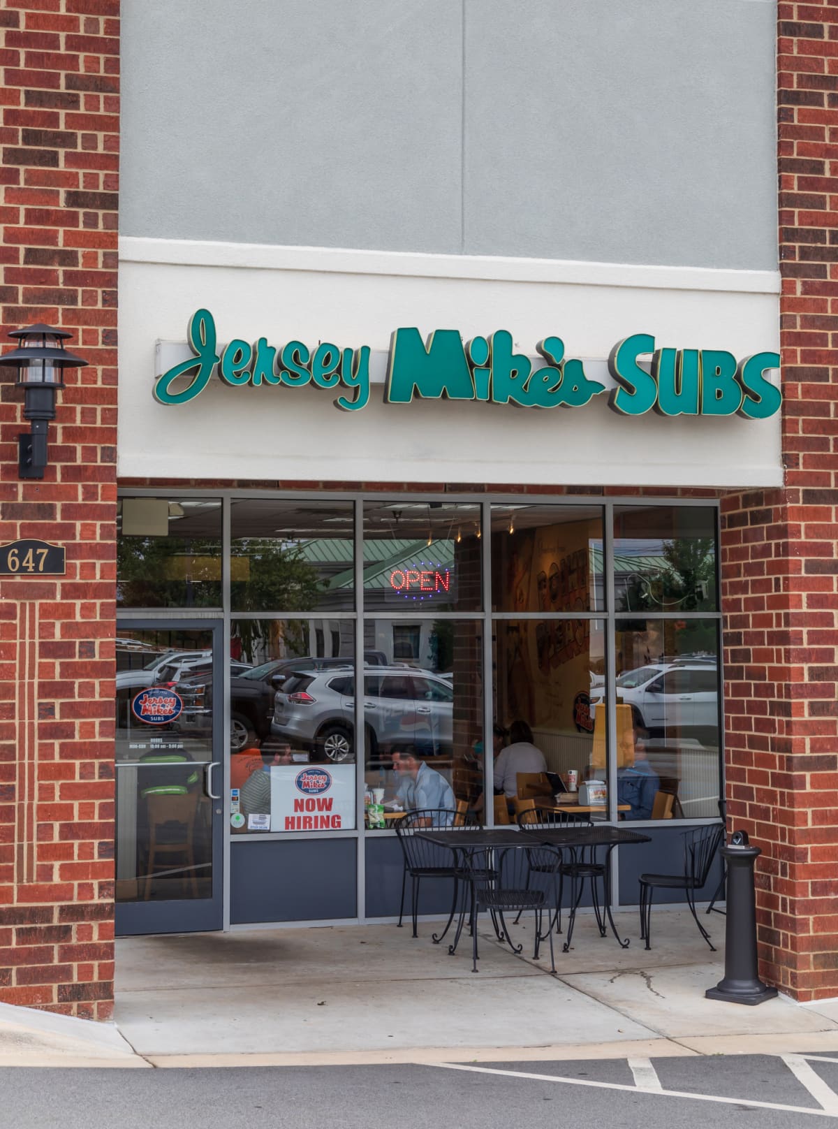 A Jersey Mike's storefront with outside seating