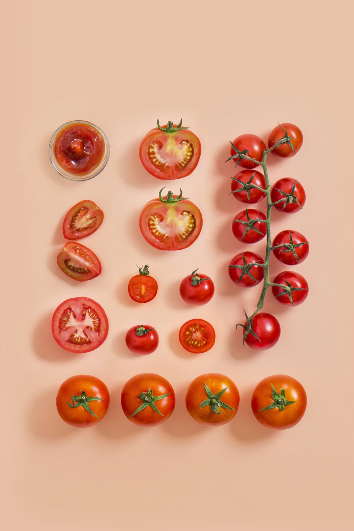 Various type of tomato on pink background