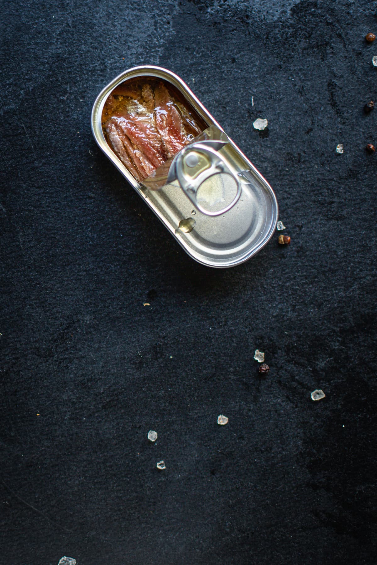 anchovies canned fish in a tin can seafood top view copy space for text food