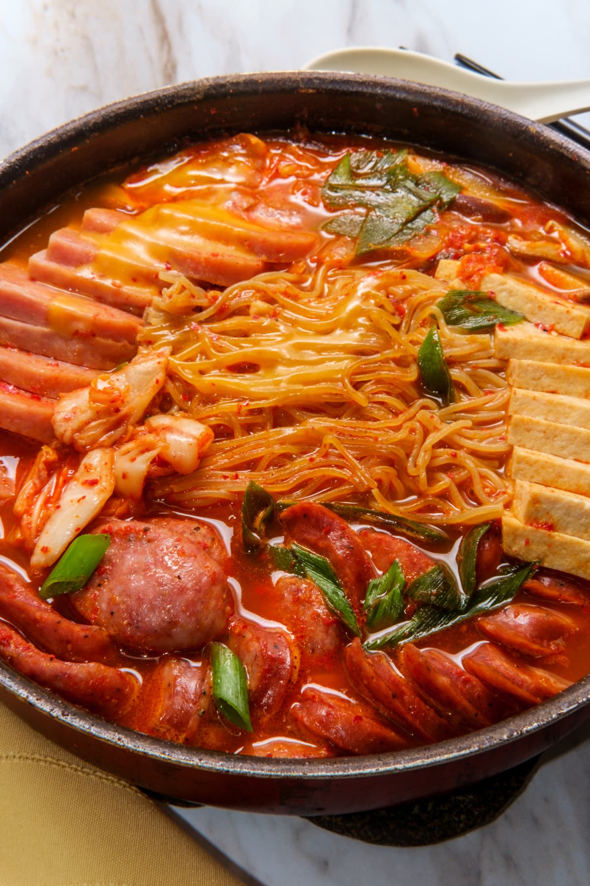 Korean comfort food army base stew also known as Budae-jjigae with sausage tofu and canned ham