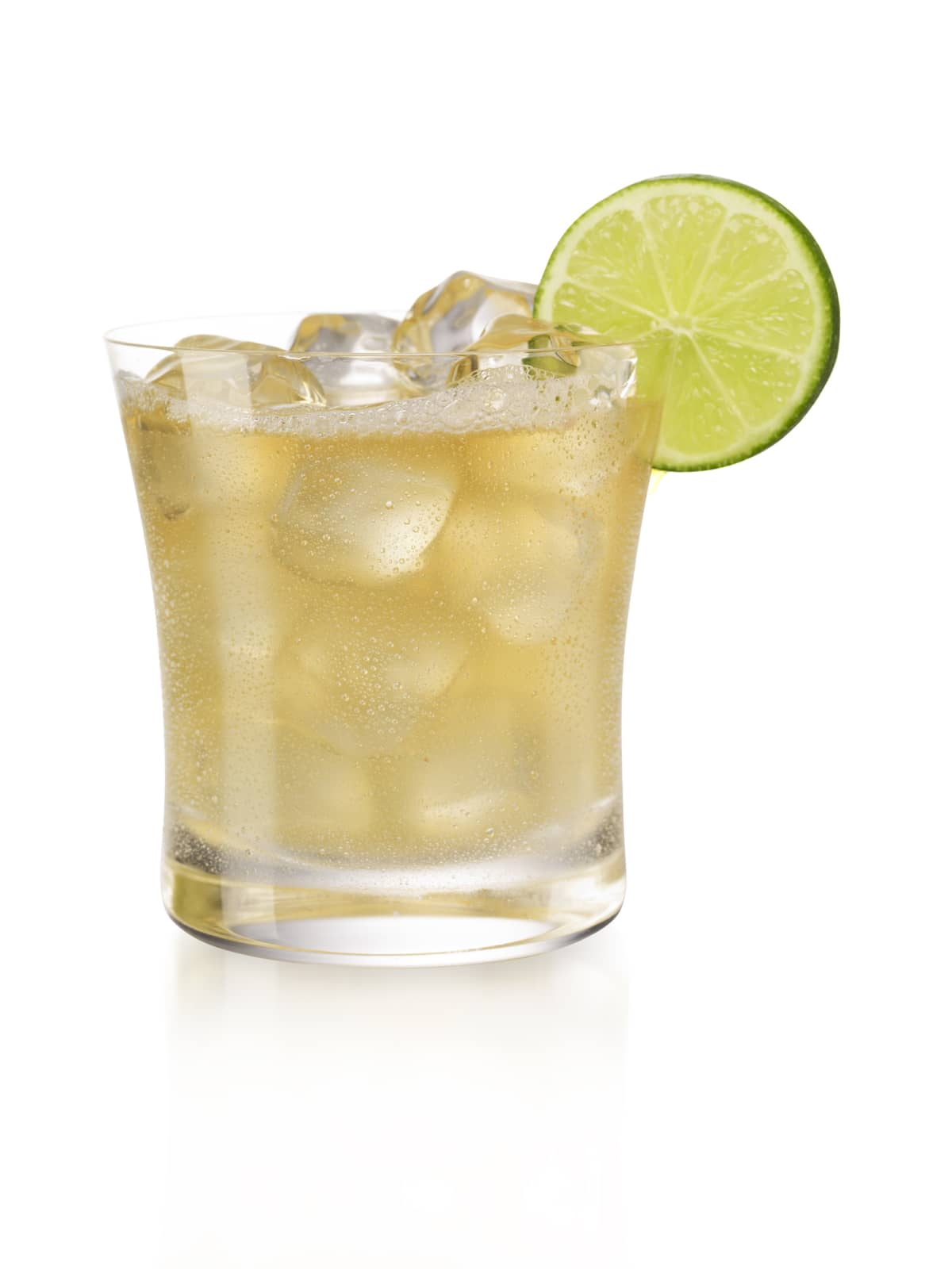 A cold margarita over Ice with a lime garnish, isolated on white