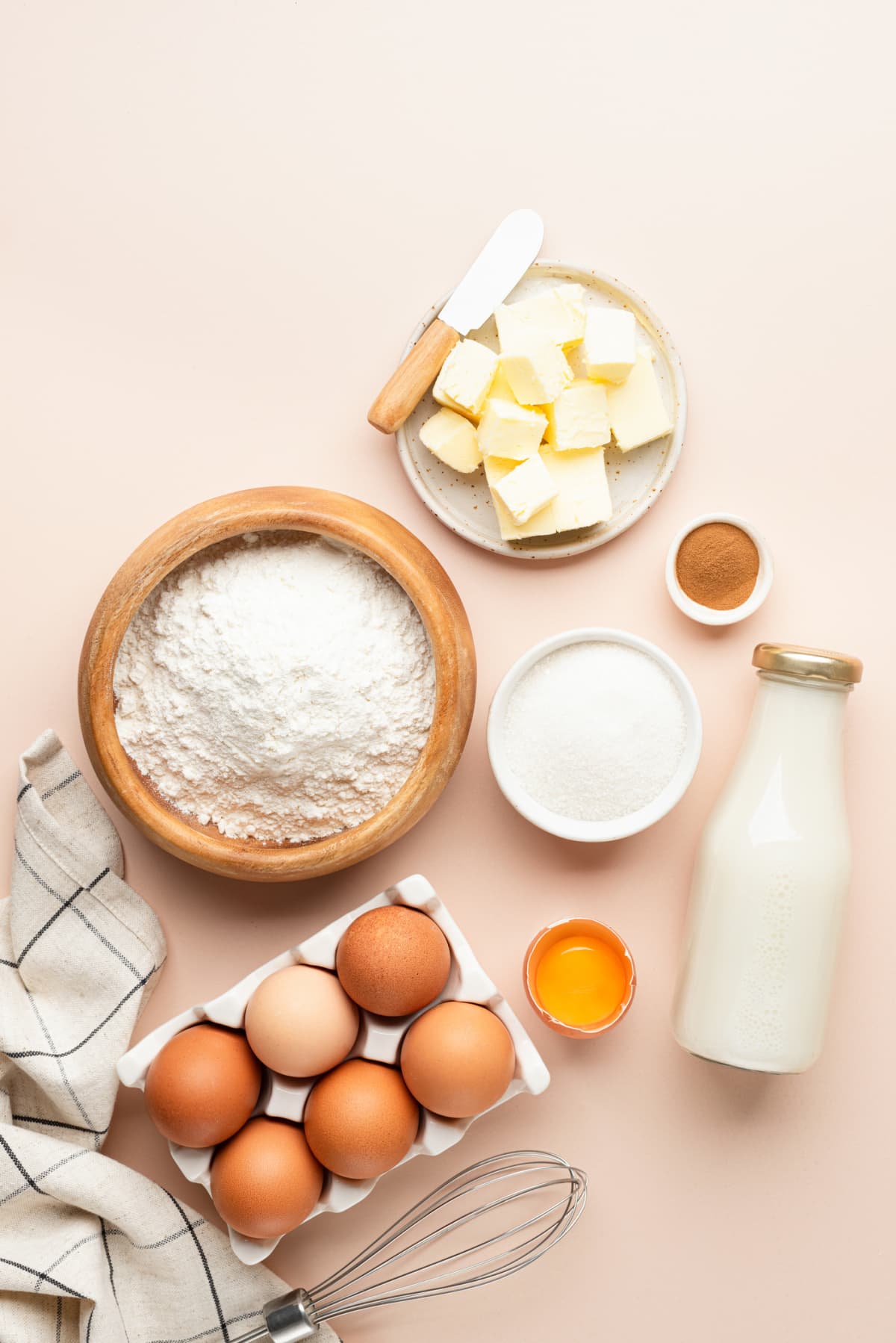 Baking ingredients for cakes, bread, cookies, or pastries on beige background