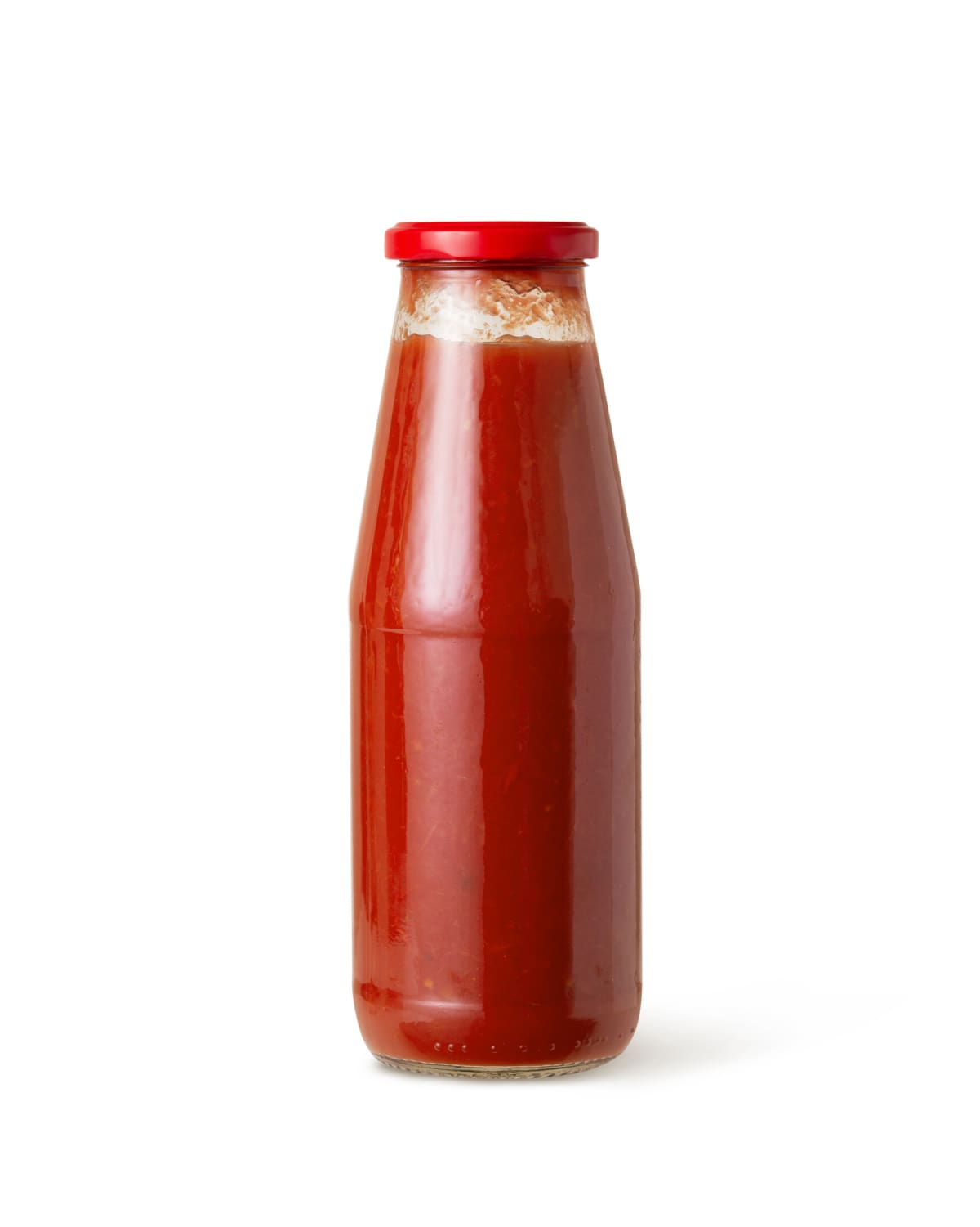 Tomato sauce in glass jar on white background