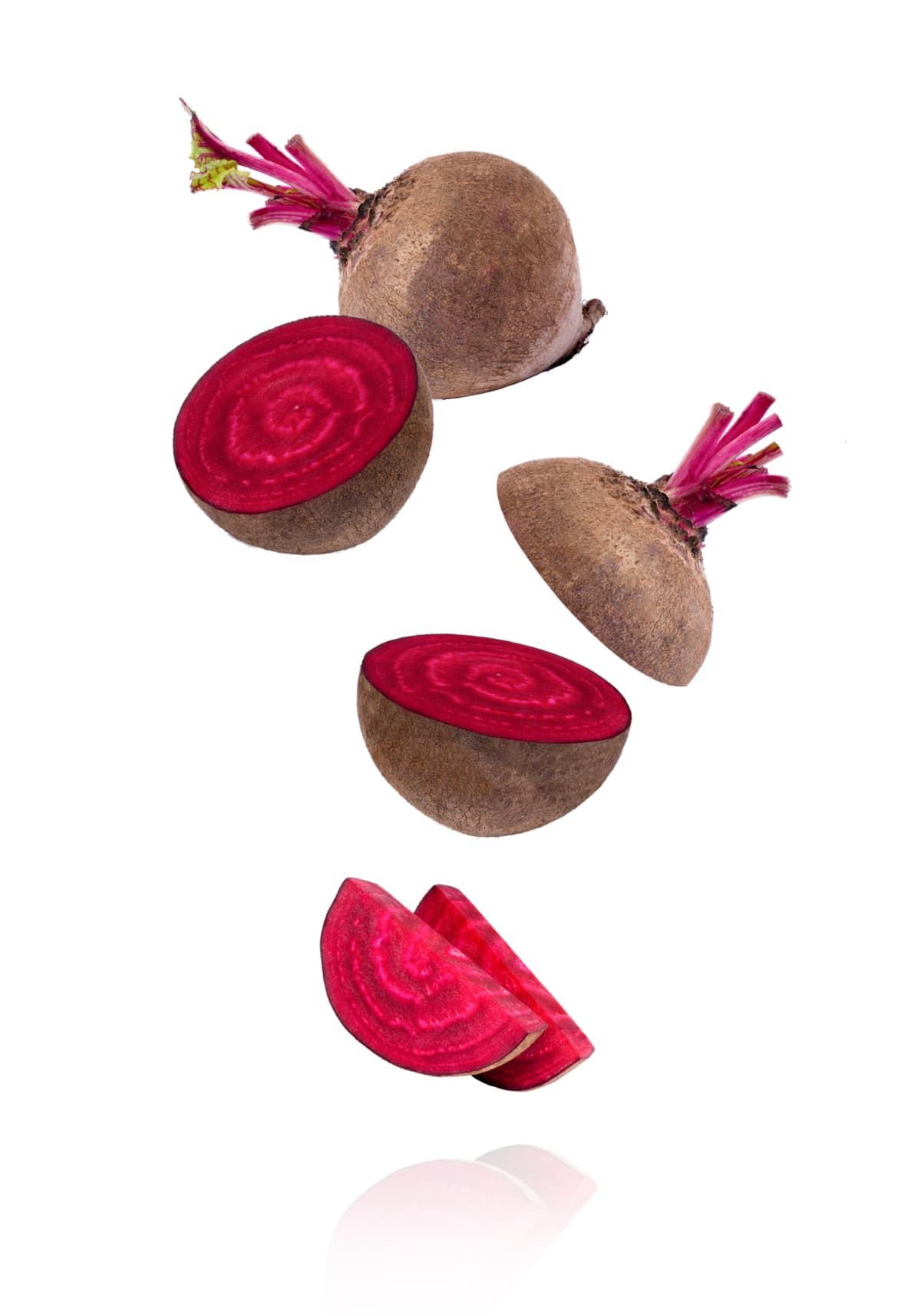 Beetroot and half sliced flying in the air isolated on white background
