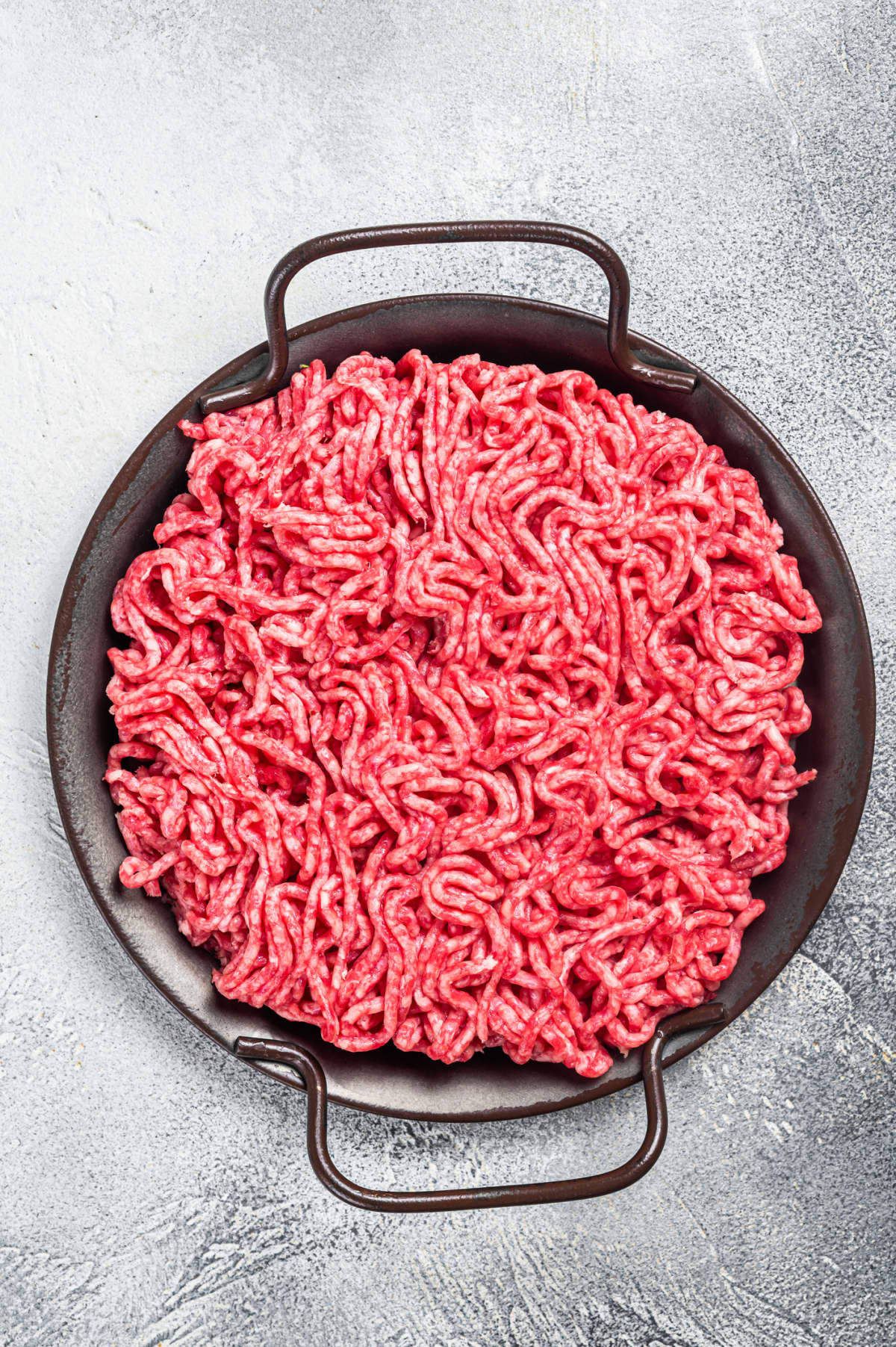 Raw mince ground meat in a kitchen pot