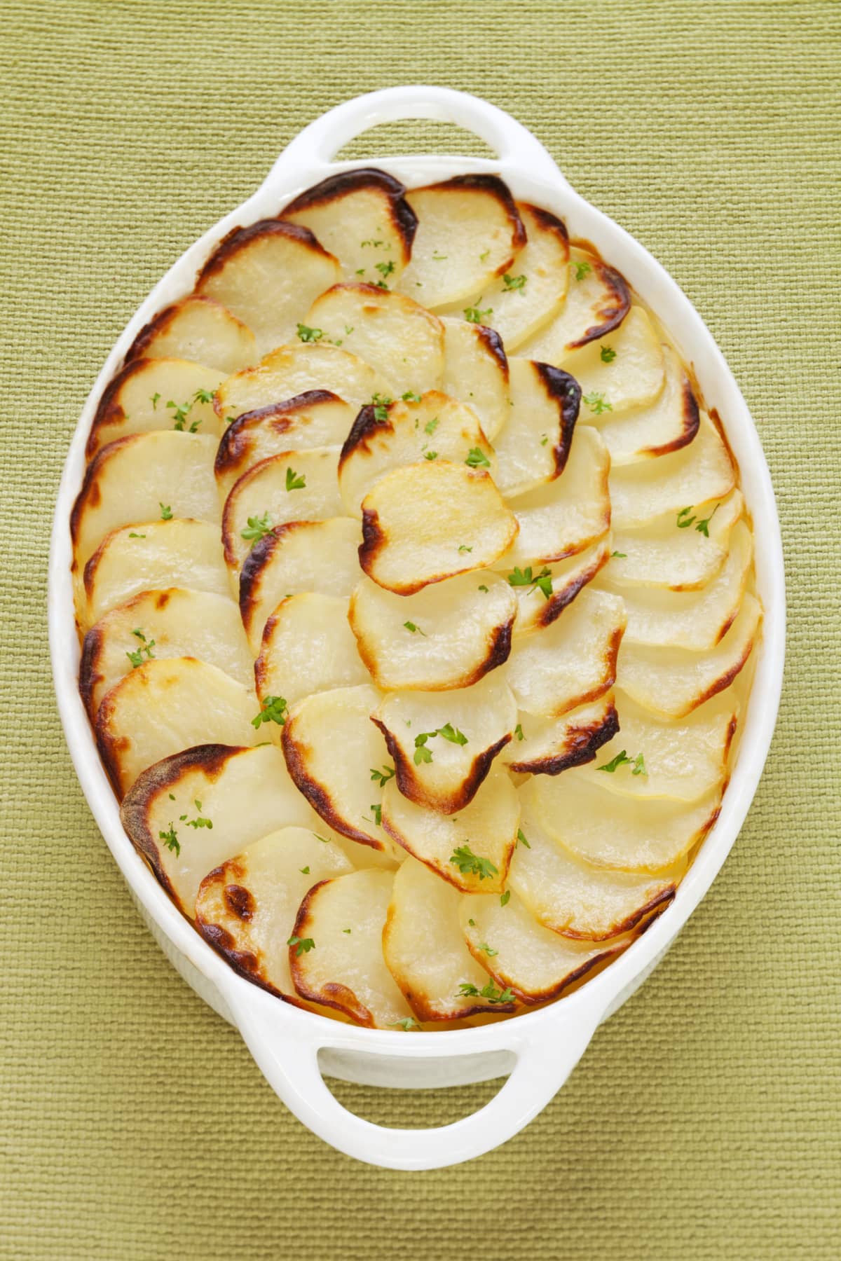 Scalloped potatoes in white baking dish