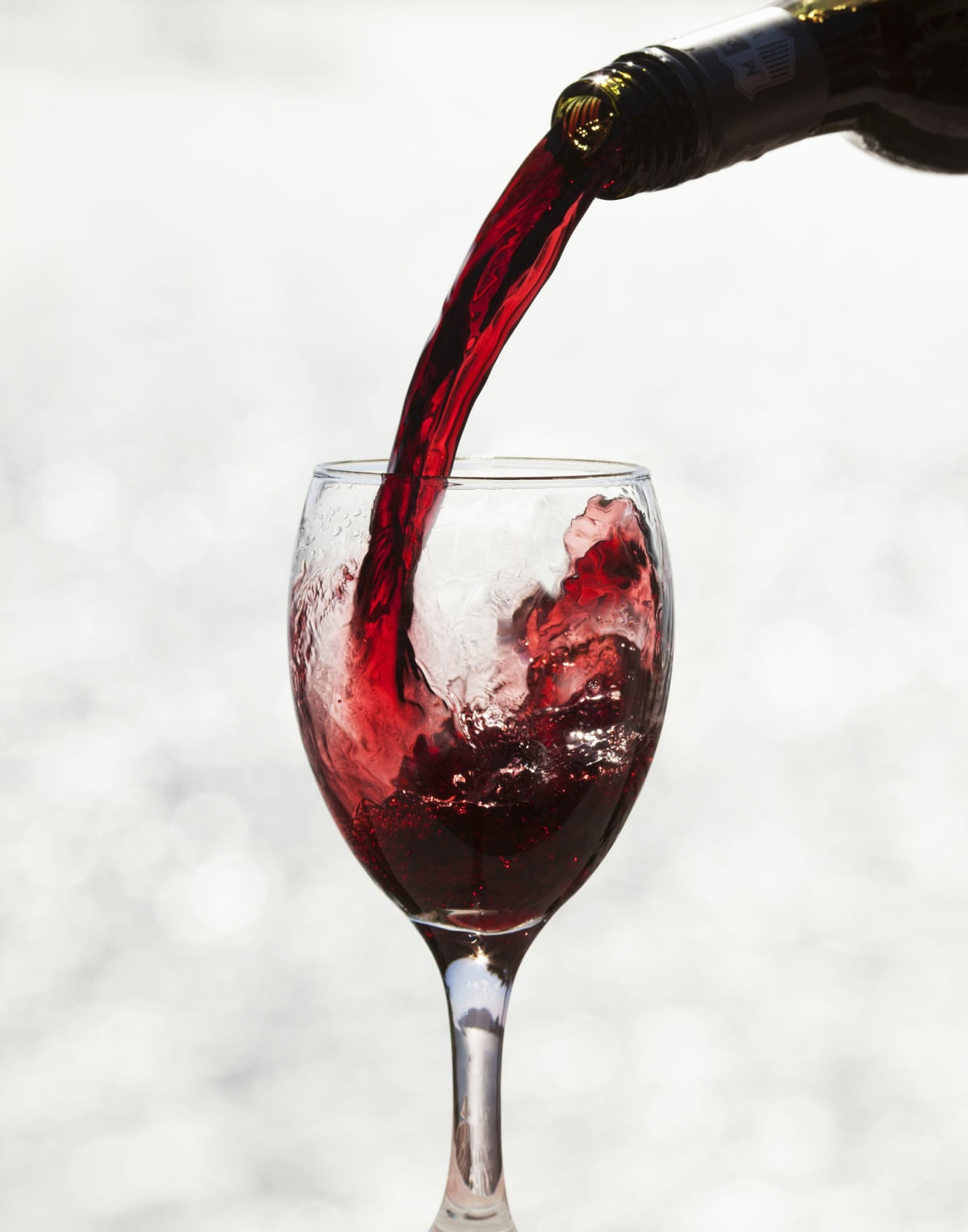 Red wine pouring into glass.