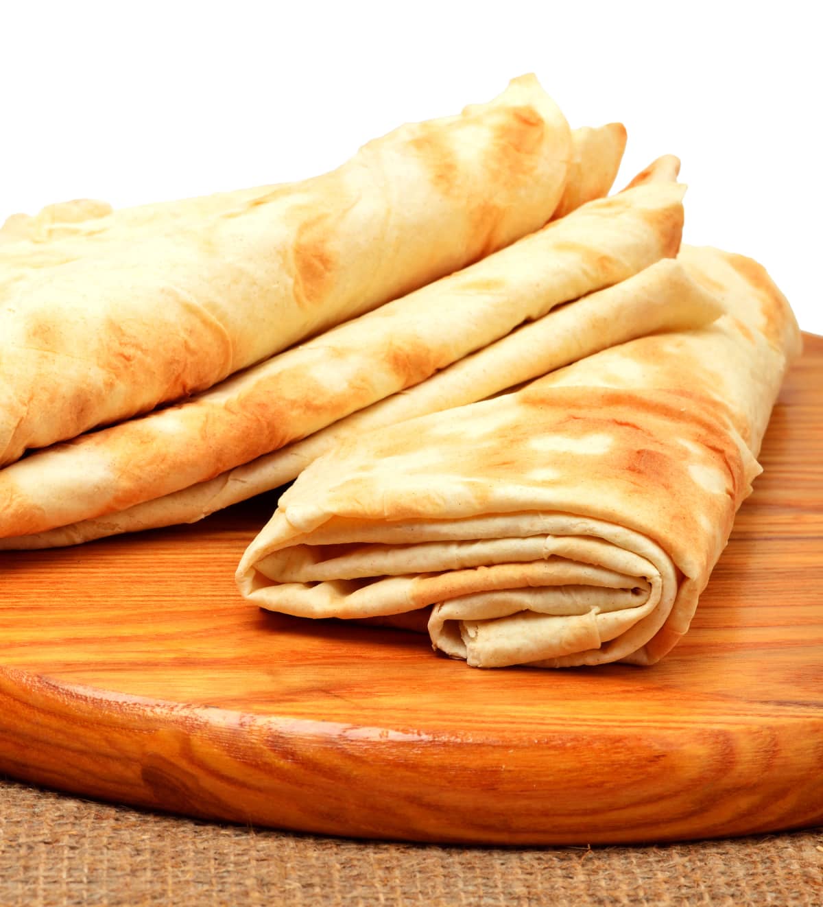 Lavash, tortilla wrap Bread on the cutting board isolated on white