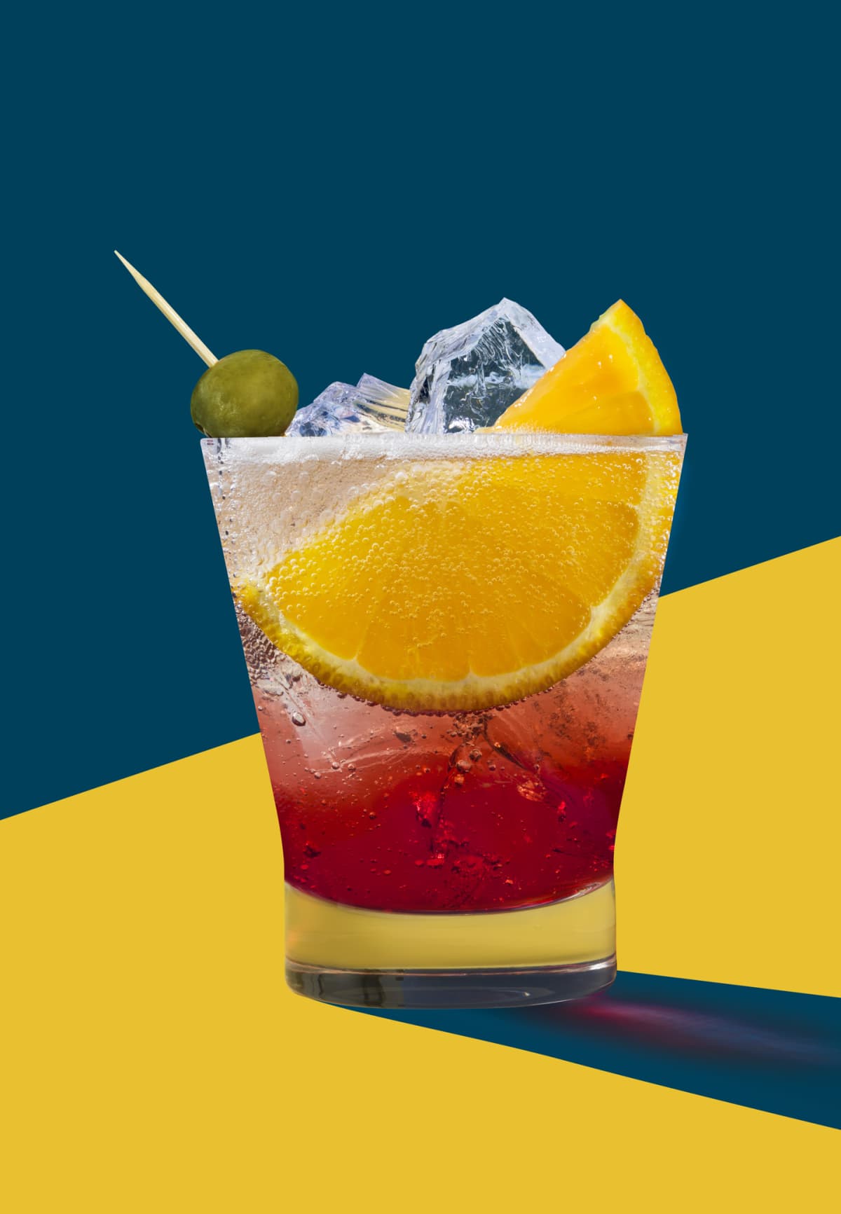 Negroni cocktail with toothpick in olive on a blue and yellow background