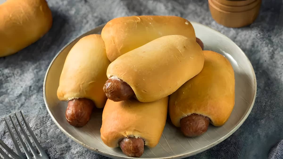 Sausage kolaches piled together on a plate