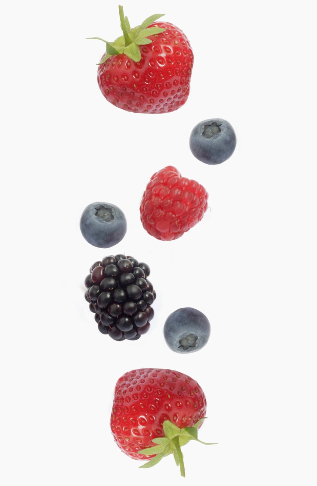 Various berries falling on white background