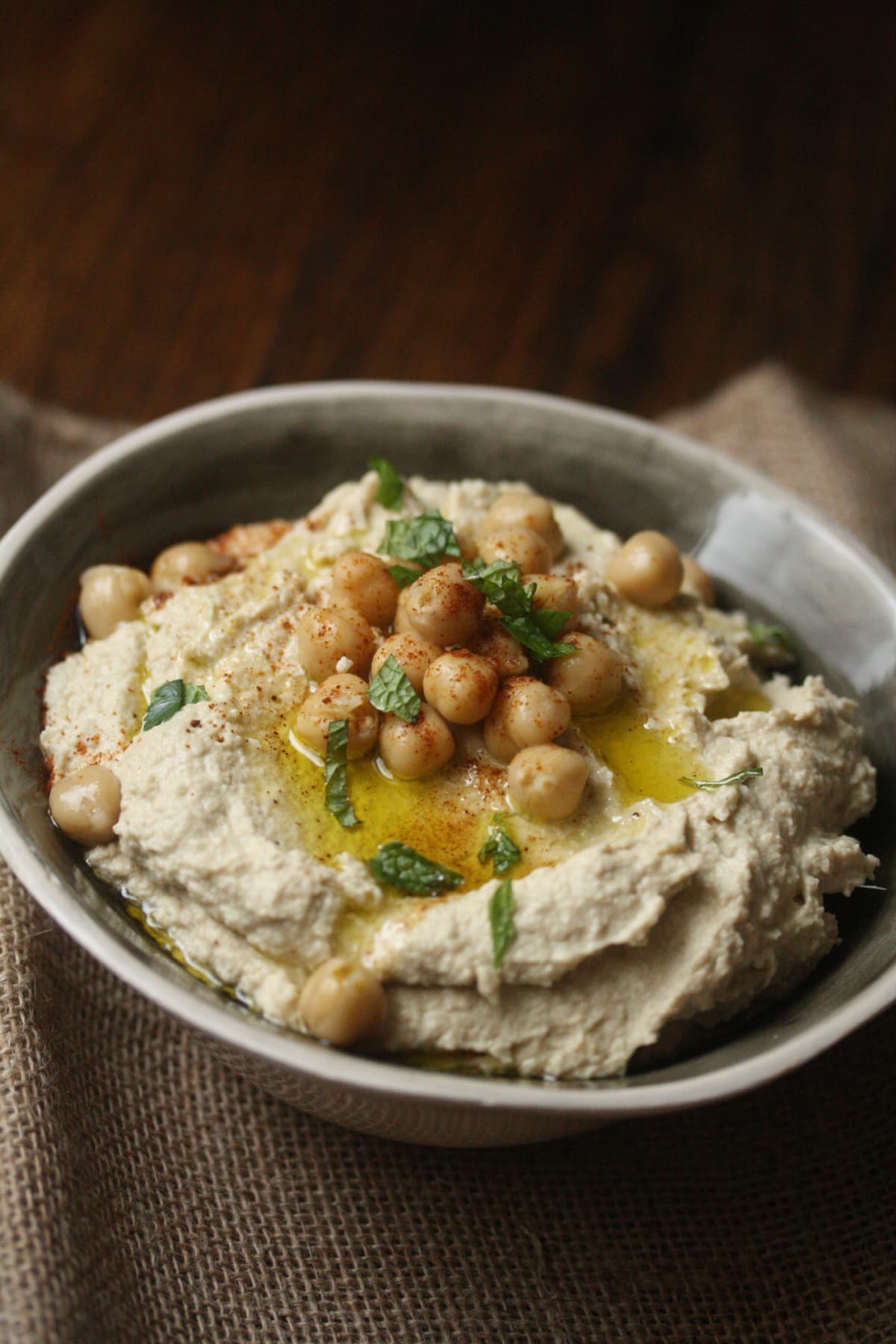 Traditional homemade chickpea hummus with olive oil and spices