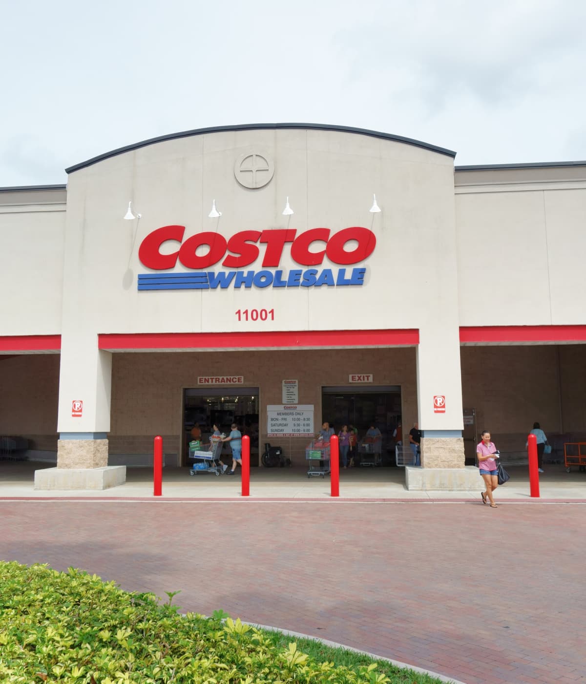 West Palm Beach, USA - April 18, 2014: A Costco Wholesale store in West Palm Beach, Florida. Costco is a combined department store and supermarket that sells in bulk and requires a club membership to shop. Customers are visible going in and out  of the store entrances. 