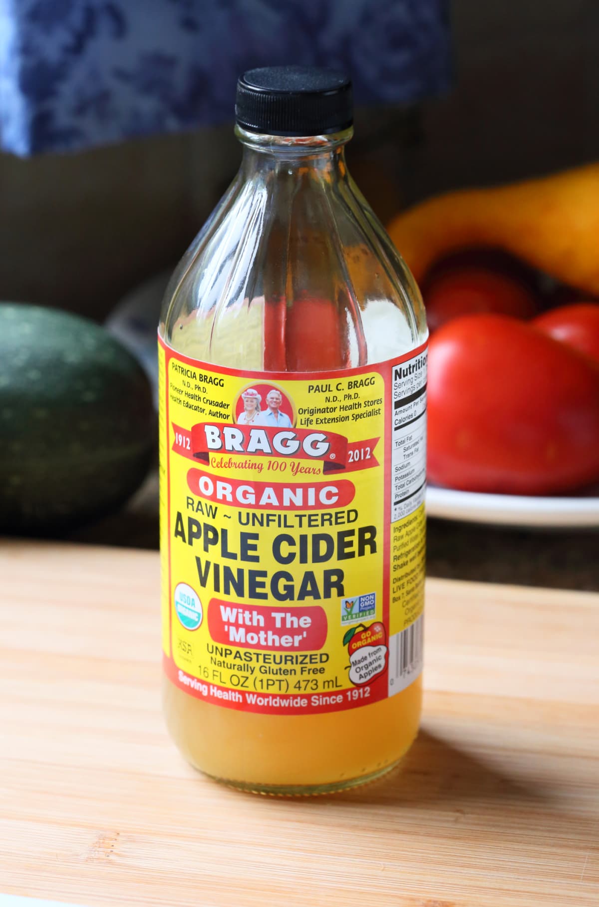 Homemade apple vinegar, white wine or apple cider in a tall bottle. Eco-friendly food, fermented foods.