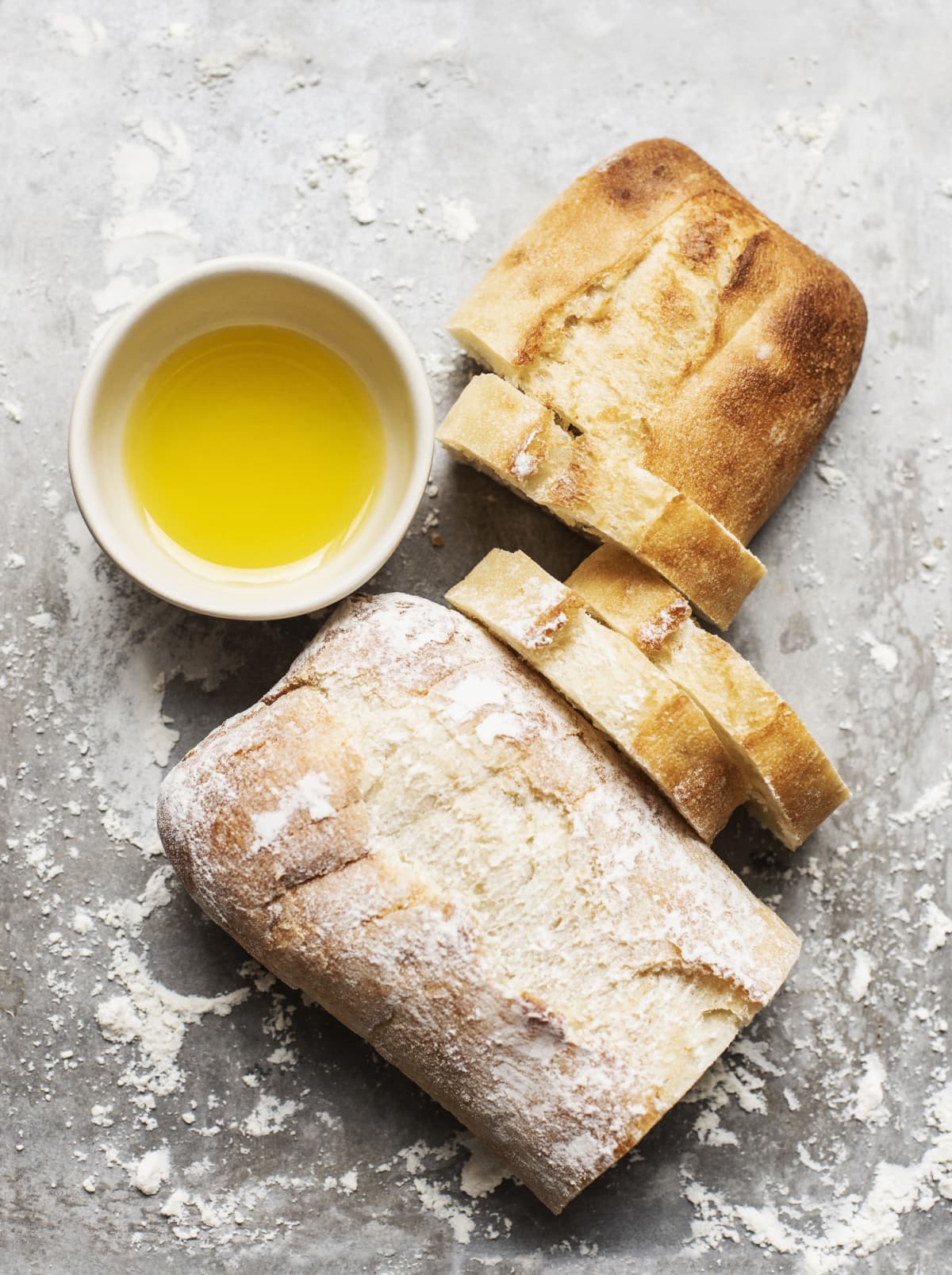 Sliced sourdough bread and olive oil for dipping