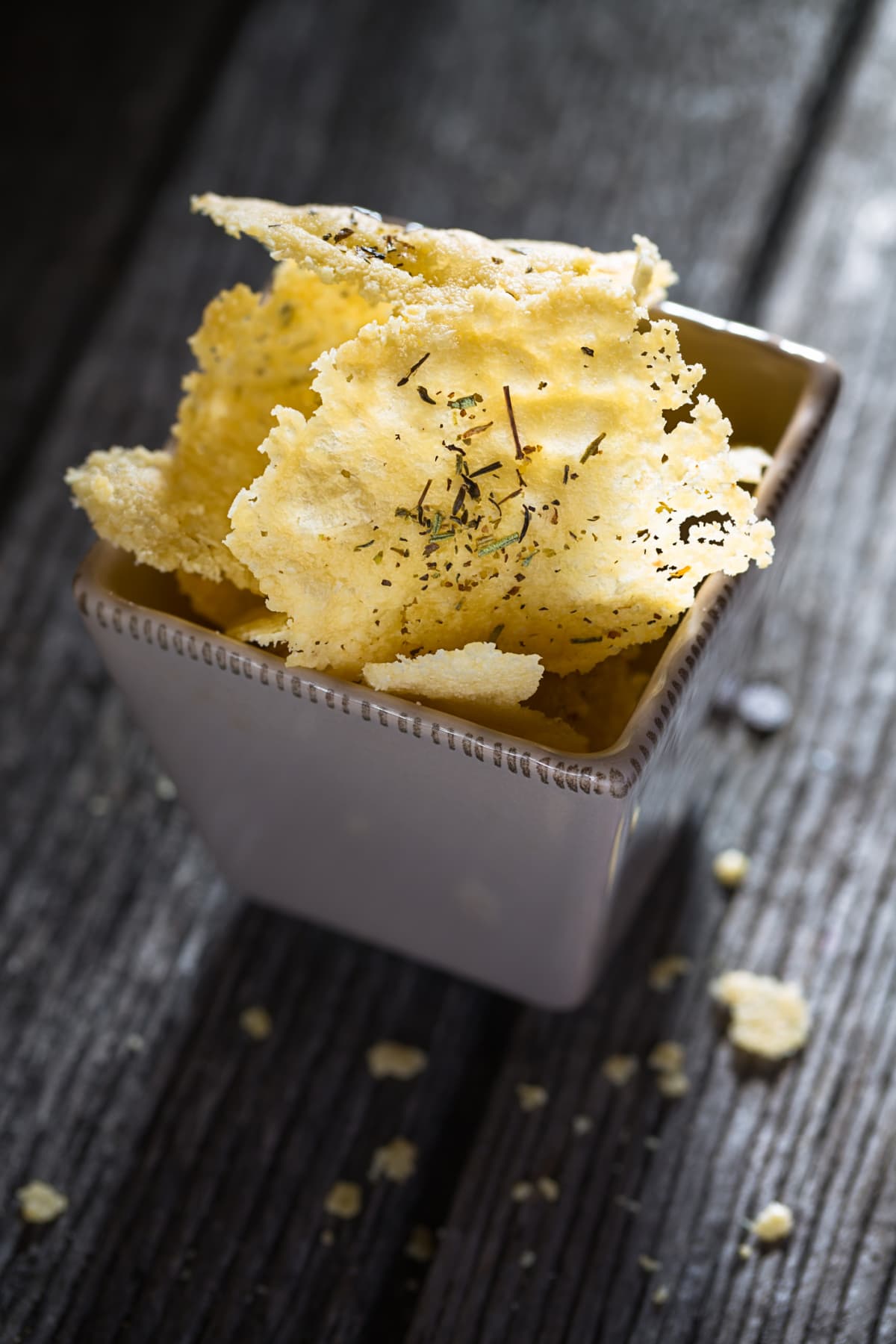 homemade parmesan chips on wood background