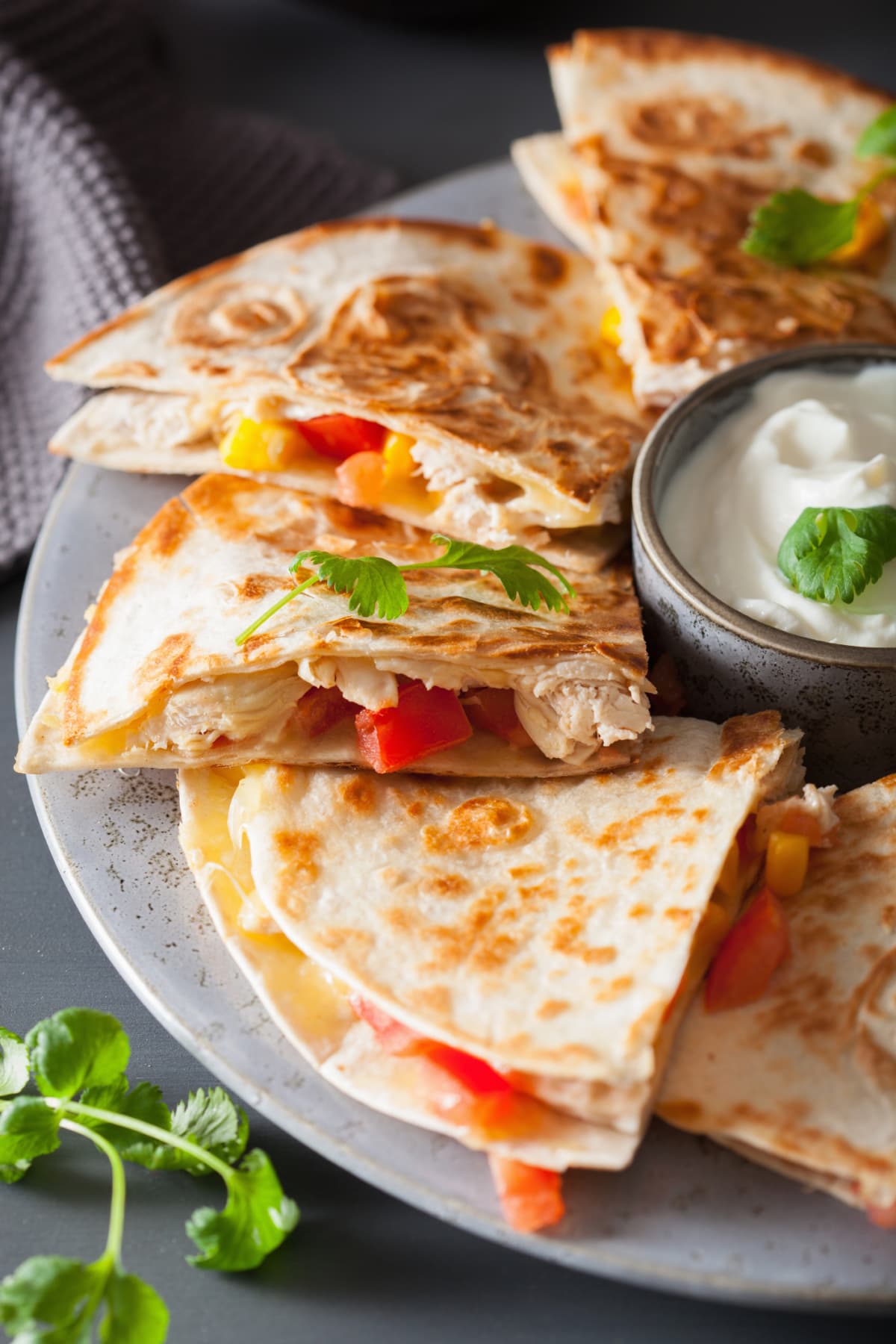 Mexican quesadilla with chicken, tomato, sweet corn, cheese, and sour cream
