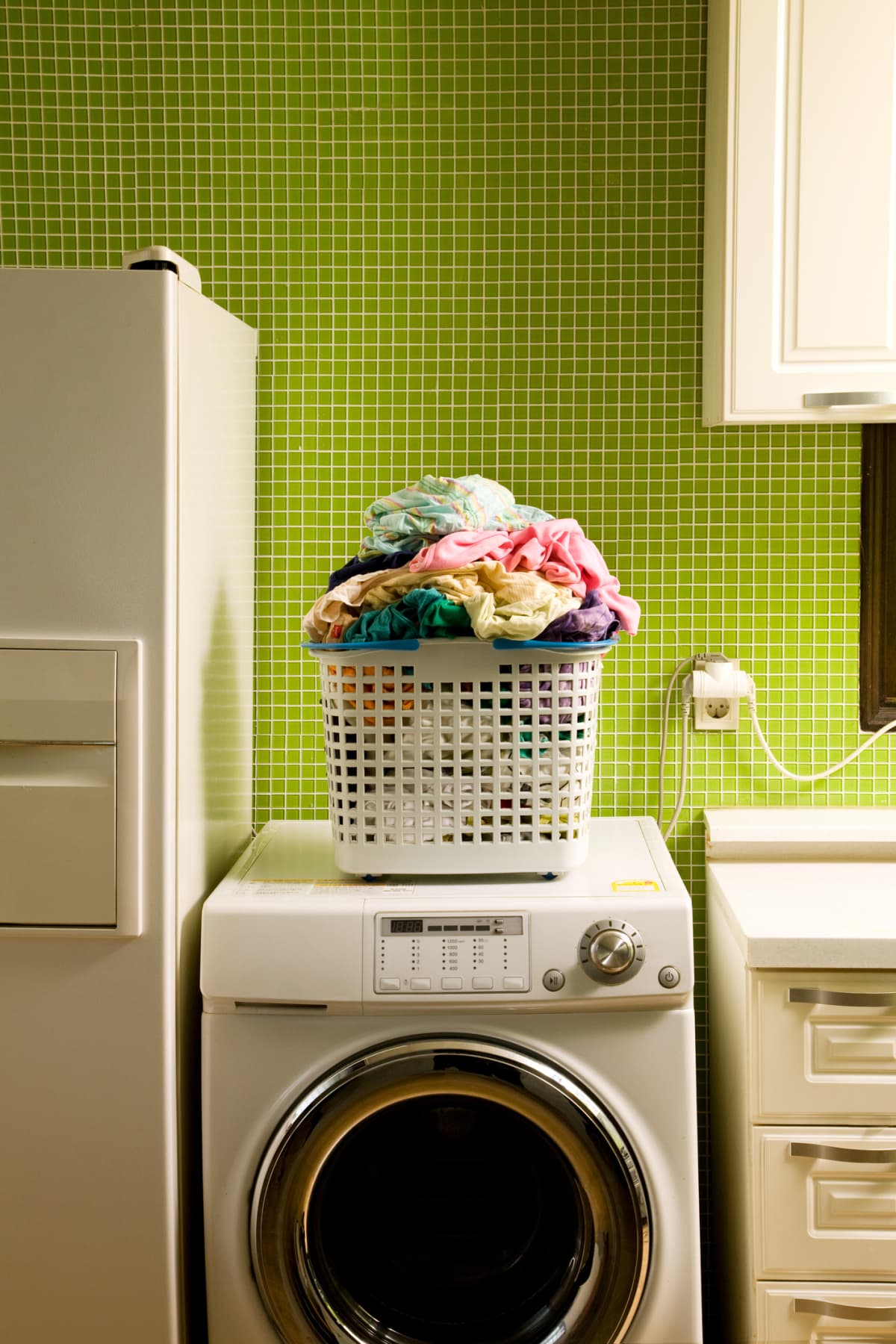 Shot of an unrecognizable woman doing her laundry at home