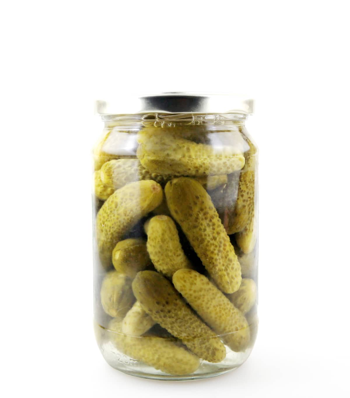 Jar of small pickled cucumbers on a white background