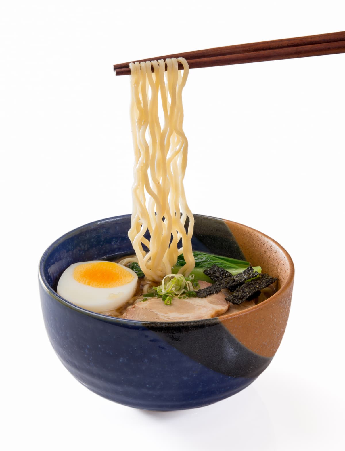 Japanese ramen noodles held over a bowl with chopsticks