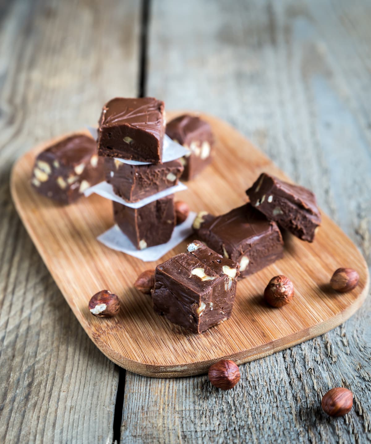 Fudge with hazelnuts on a wooden board