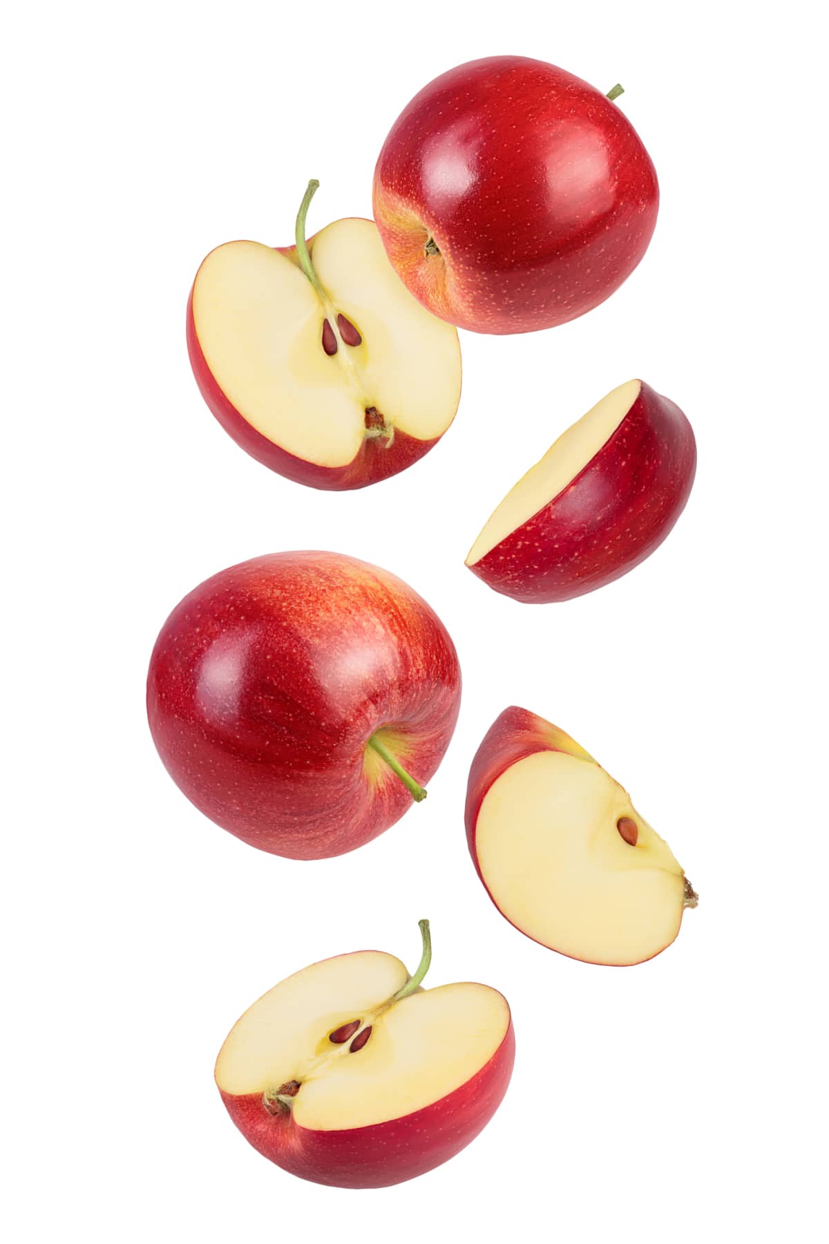 Falling red apple slice isolated on white background with clipping path.