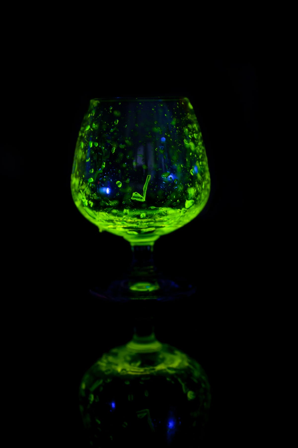 Glass of whiskey glow in the dark.