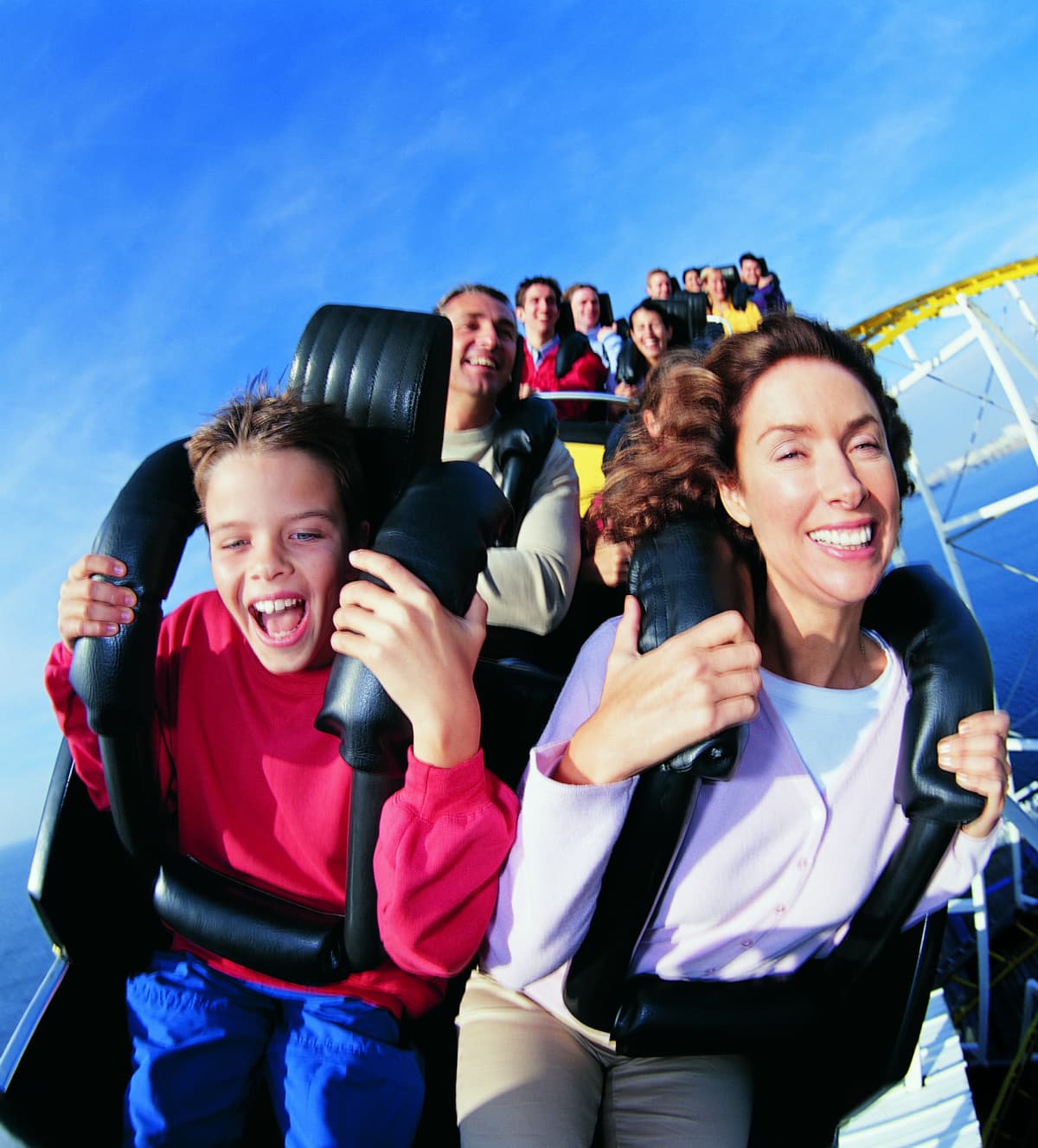People enjoying the excitement of being on a roller coaster
