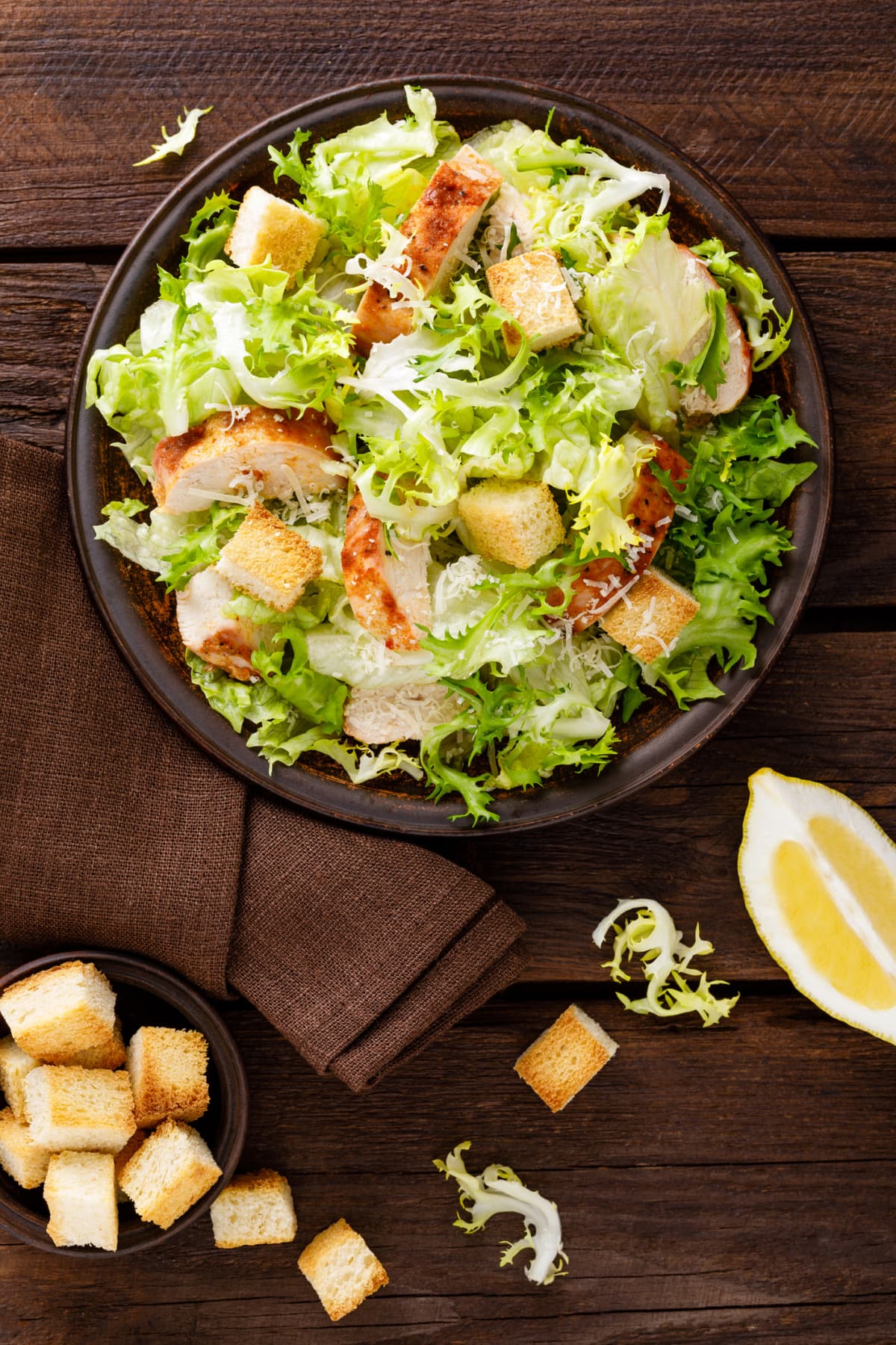 Caesar salad with grilled chicken meat, fresh lettuce, parmesan cheese, and fried croutons