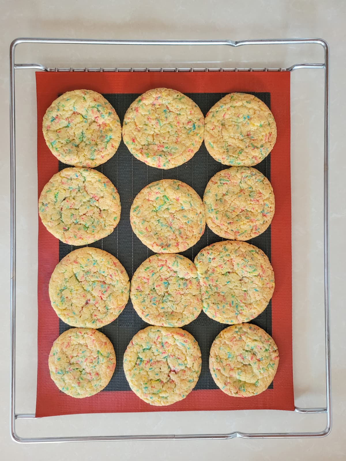 Overhead view of sugar cookies with sprinkles on tray