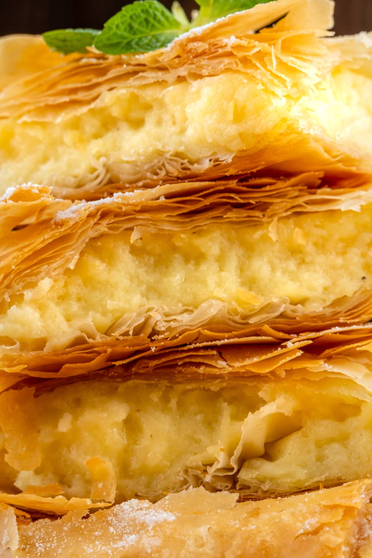 Pieces of phyllo dough Greek pie bougatsa stacked on top of each other. Close-up. Macro. Selective focus.