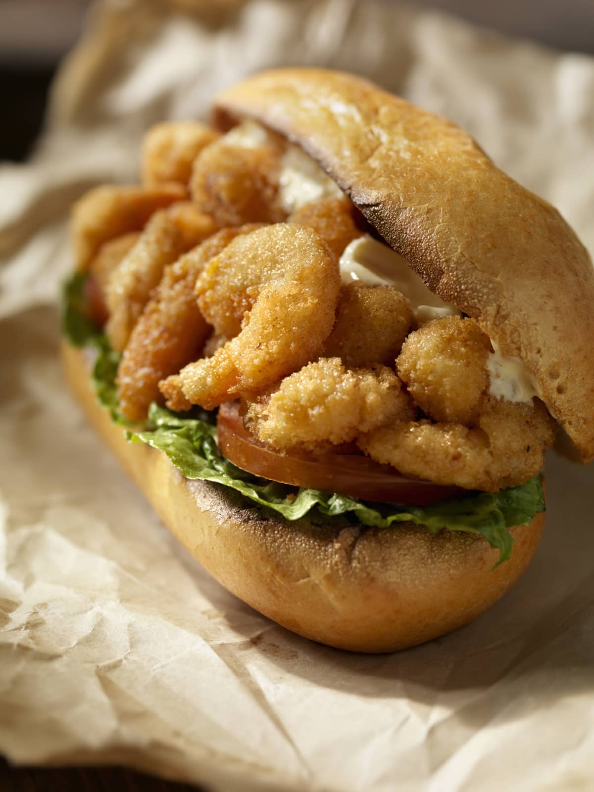 Shrimp Po Boy Sandwich on a Toasted Crusty French Roll with Lettuce, Tomato and Mayo