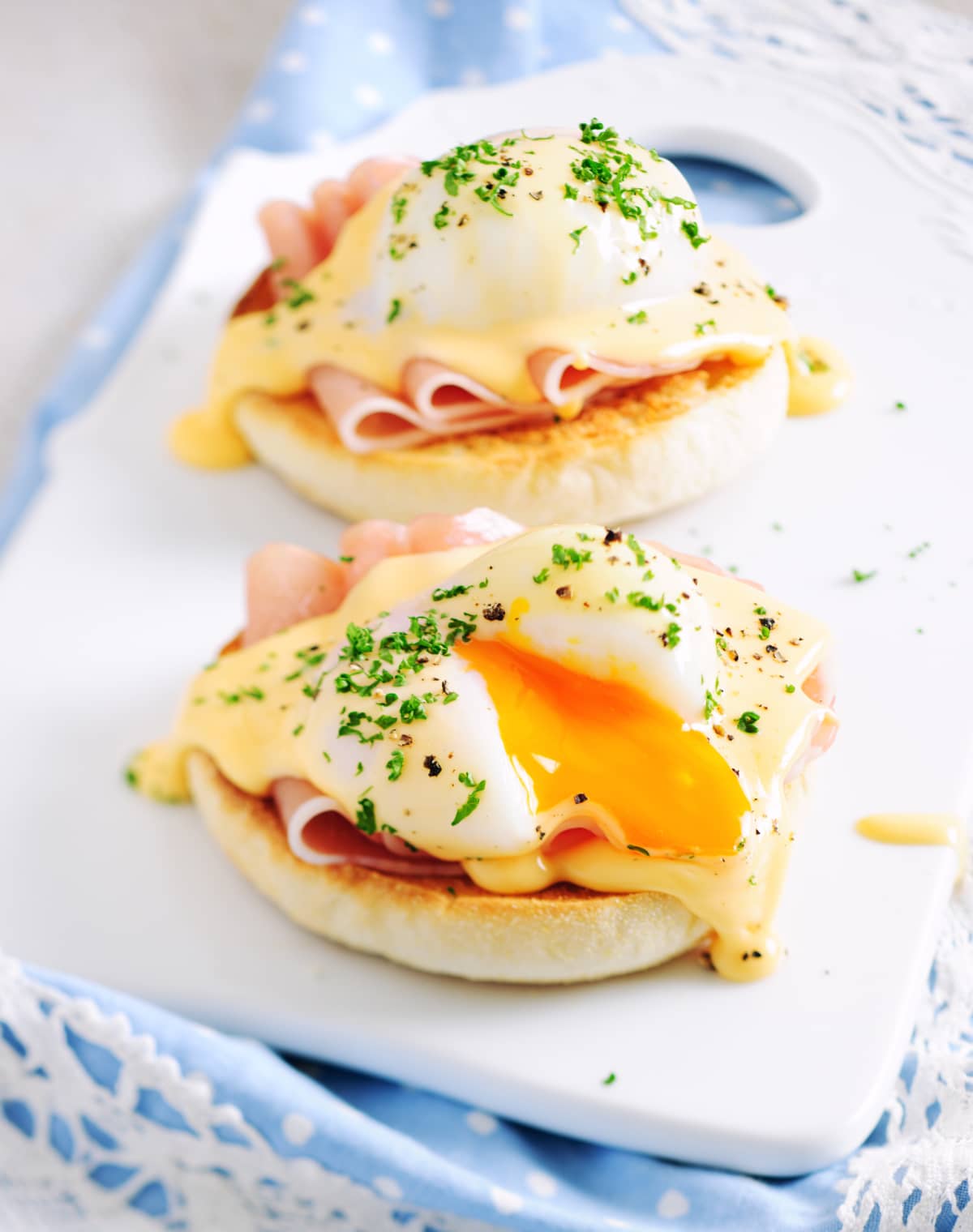 Eggs Benedict Sandwiches Served on Porcelain Board. Selective Focus, Shallow DOF, Tilt&Shift Lens Used