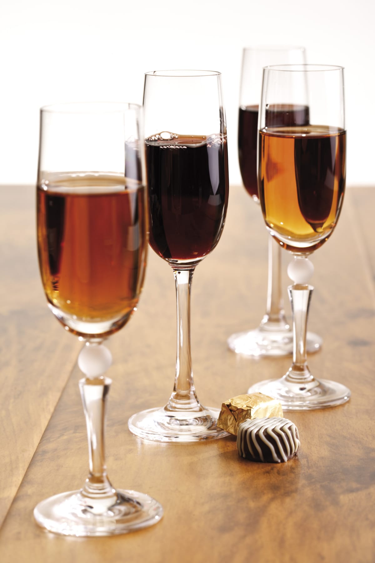 Three glasses of fortified wine on a table