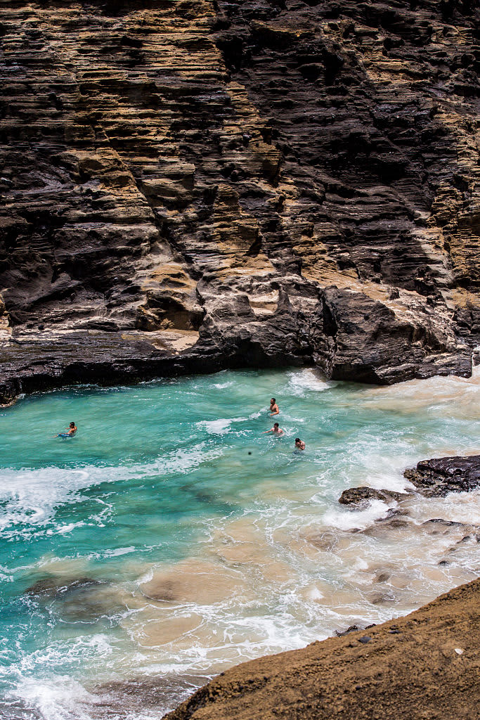Swimmers Enjoying the Teal Water, Surf, Waves and Rocky Cliffs at Halona Beach Cove 