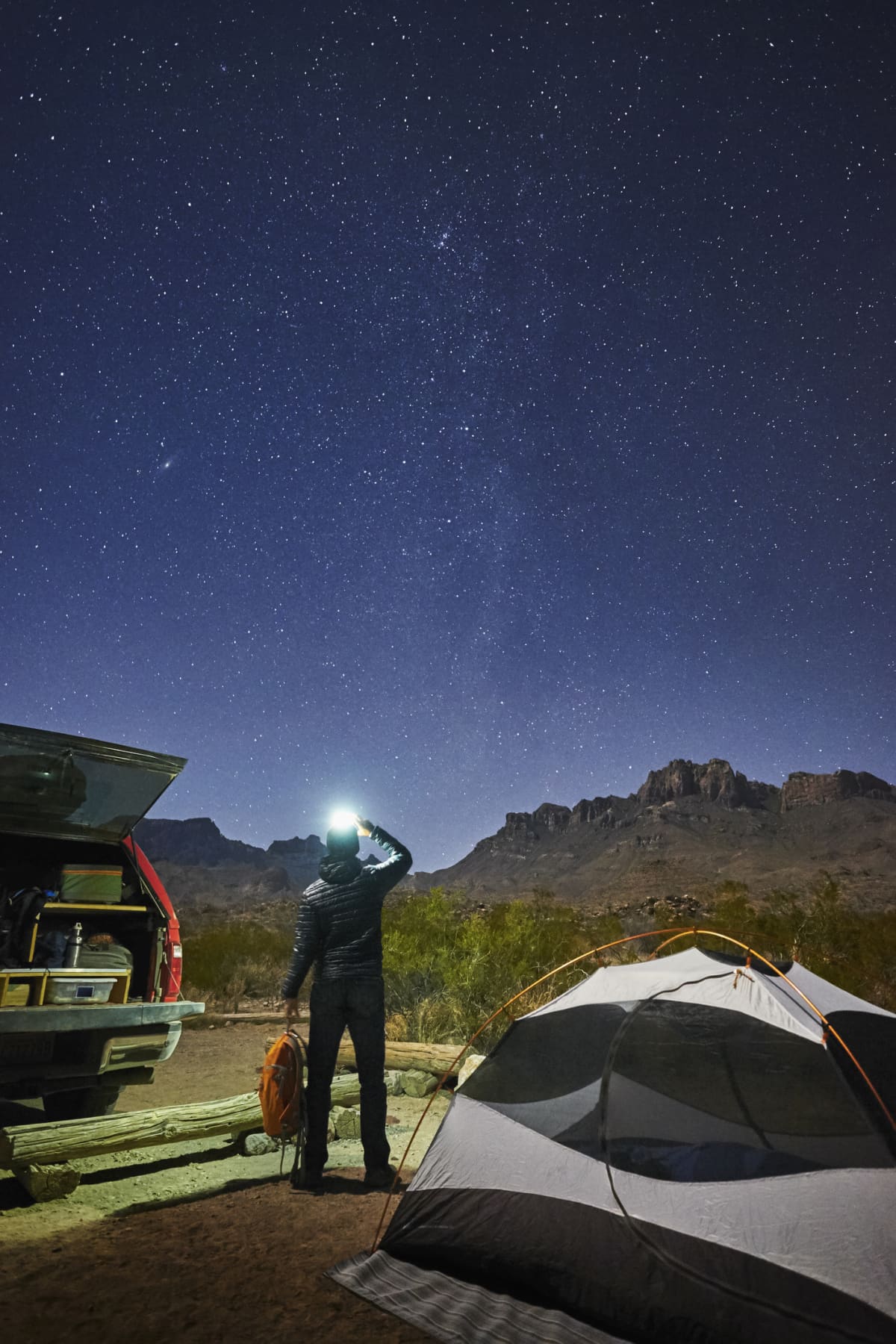 A man camping and taking a picture of the night stars in the Texas sky