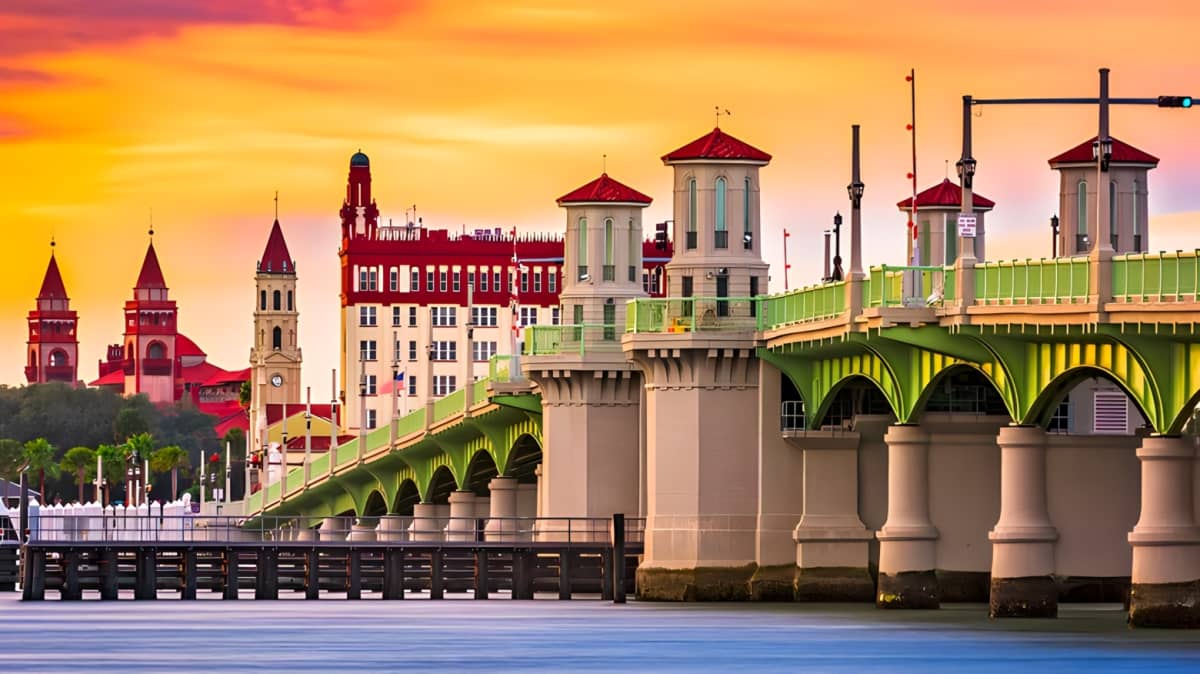 Sun sets over a green bridge in St. Augustine, Florida